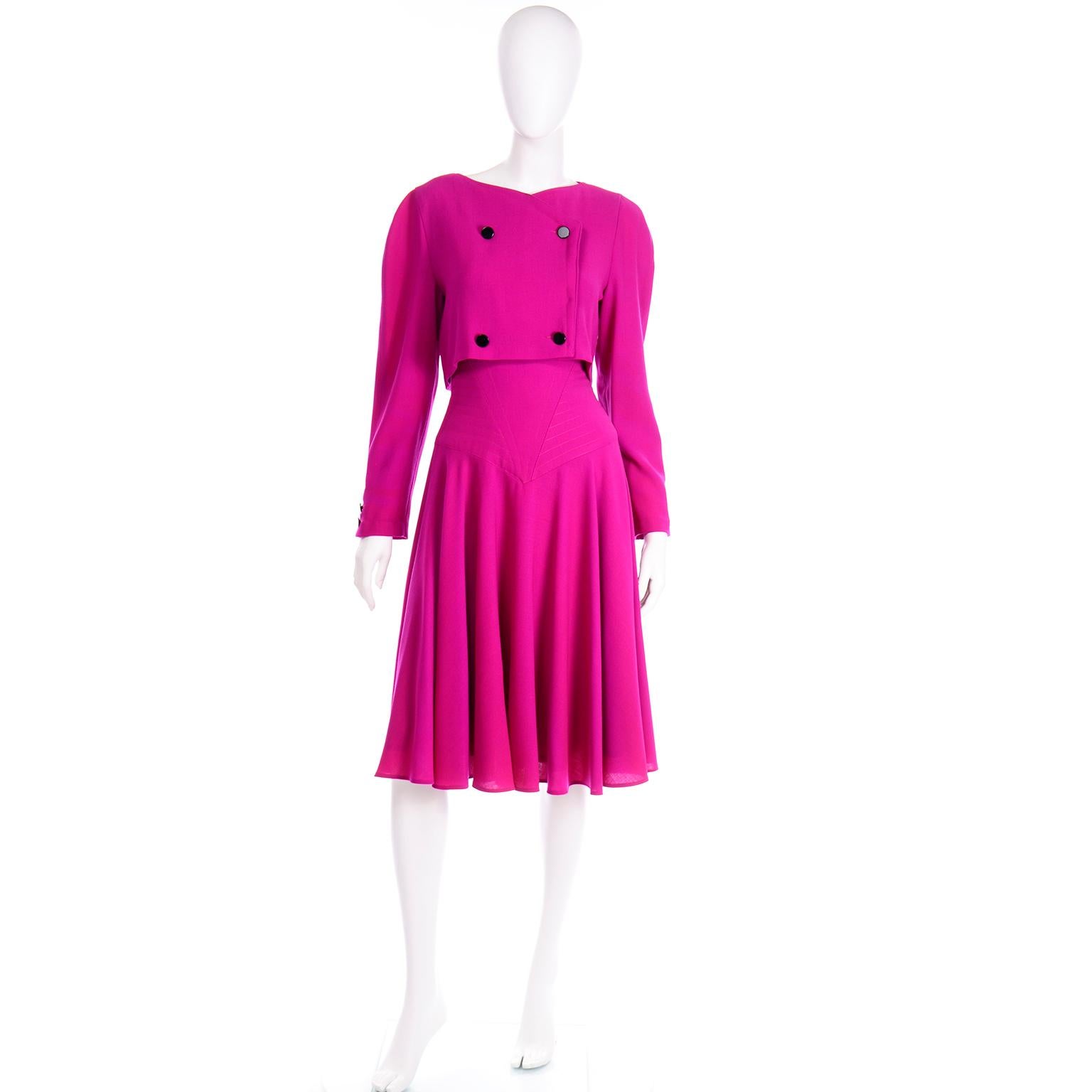 This incredible pink wool Louis Feraud dress is one of our favorites! The dress has a double breasted front detail with black enamel buttons. The back of the dress has black buttons from the nape of the neck down to the hem of the shirt. The top of