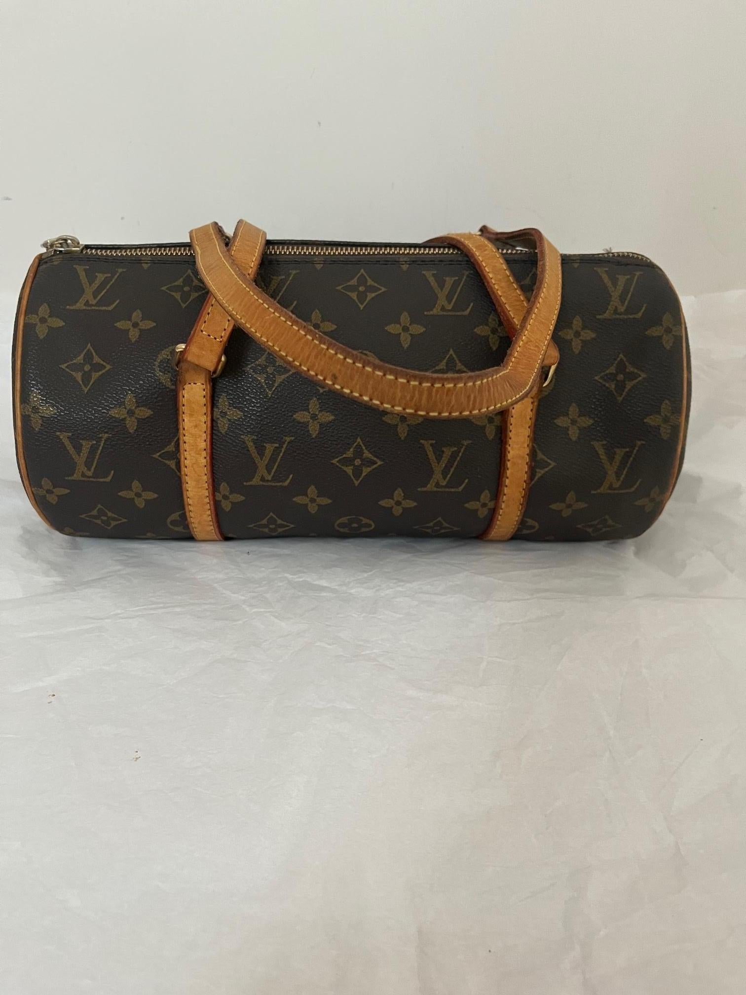 This Louis Vuitton Papillon hand/shoulder bag is in very good vintage condition and comes with a Certificate of Authentication. The bag is made of brown monogram canvas with leather trim, and has a top zip closure.
Both the inside and outside are in