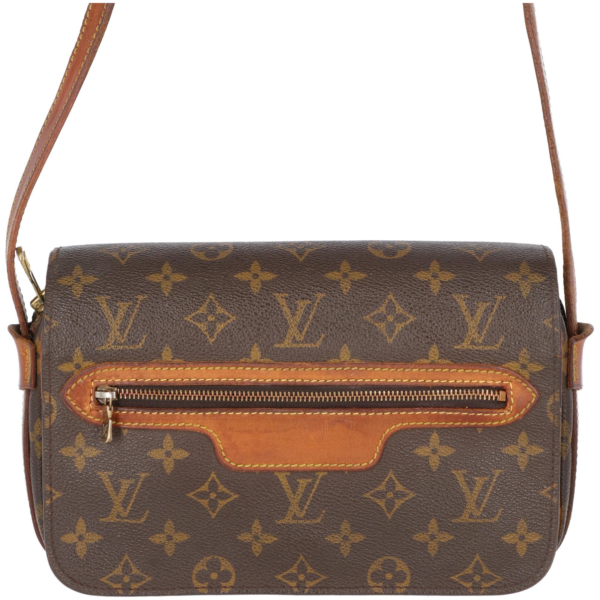 Louis Vuitton brown monogram canvas and leather shoulder bag with zip and press stud button fastening. With one front zip pocket on the flap and one zip pocket on the outer side of the bag. Shoulder strap is in brown real leather with metal buckle,