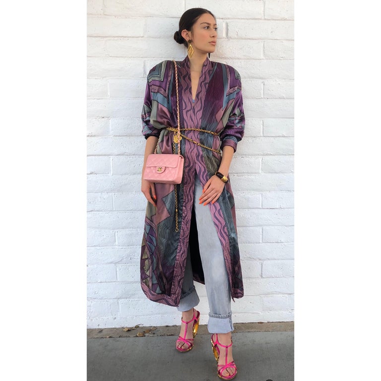 Elevate all your looks with this amazing Luanne Rimel duster! Circa 1980s, this silk duster features an all over abstract motif comprised of various geometric designs. Includes gorgeous shades of grey/blue and purple. Features a ribbed collar and
