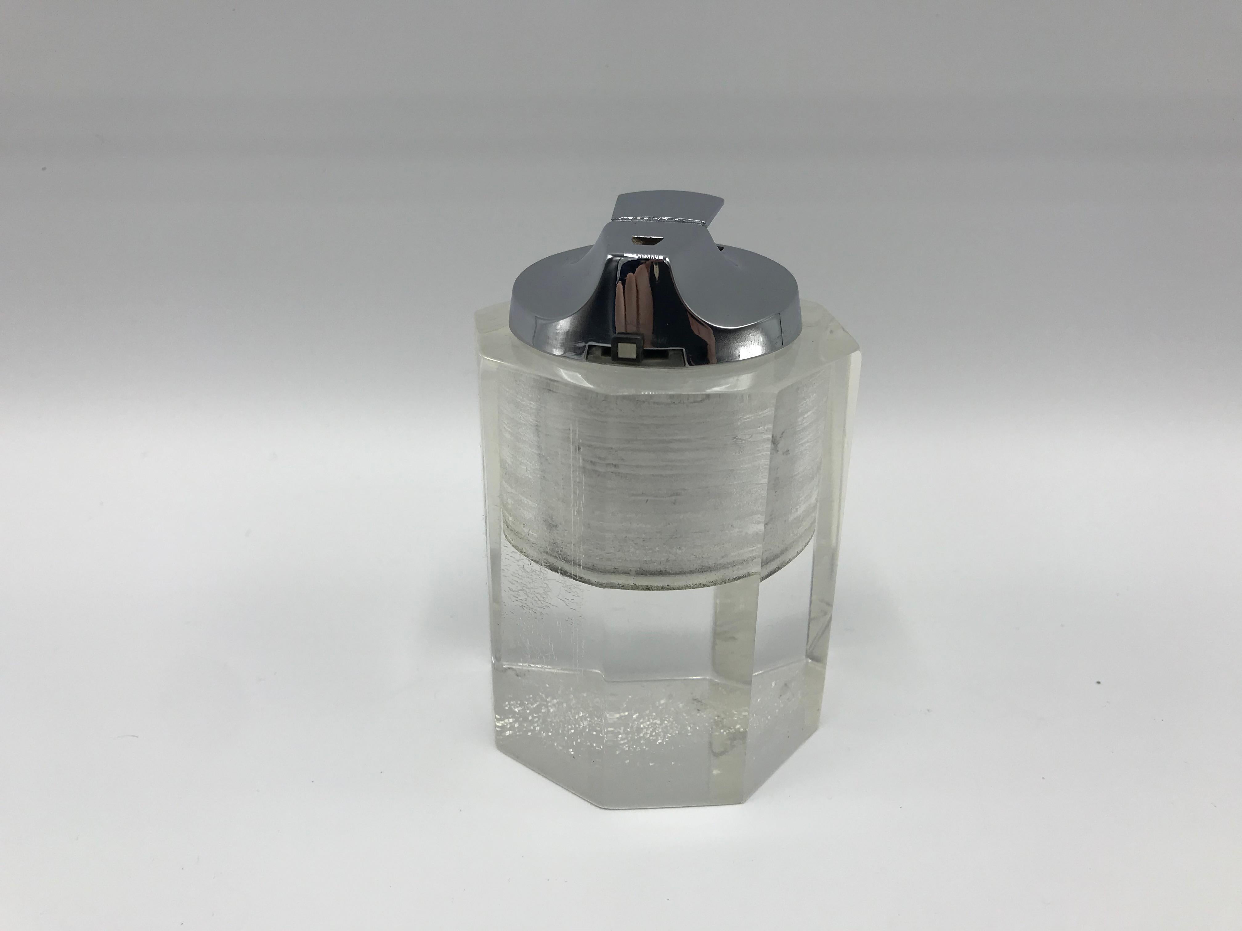 Offered is a beautiful, 1980s Lucite and chrome octagon shaped lighter. The chrome lighter mechanism is removable for easy lighter-fluid refilling. Heavy.