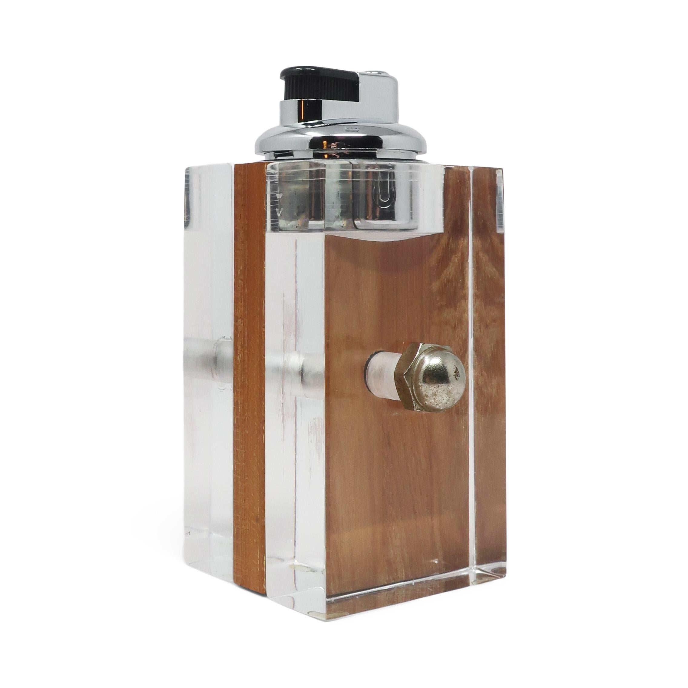 A perfectly mid-century modern Astrolite lucite and wood table lighter by the Ritts Company of Los Angeles.  The Ritts Company was owned by Herbert and Shirley Ritts, parents of famed photographer Herb Ritts.

In very good vintage condition with