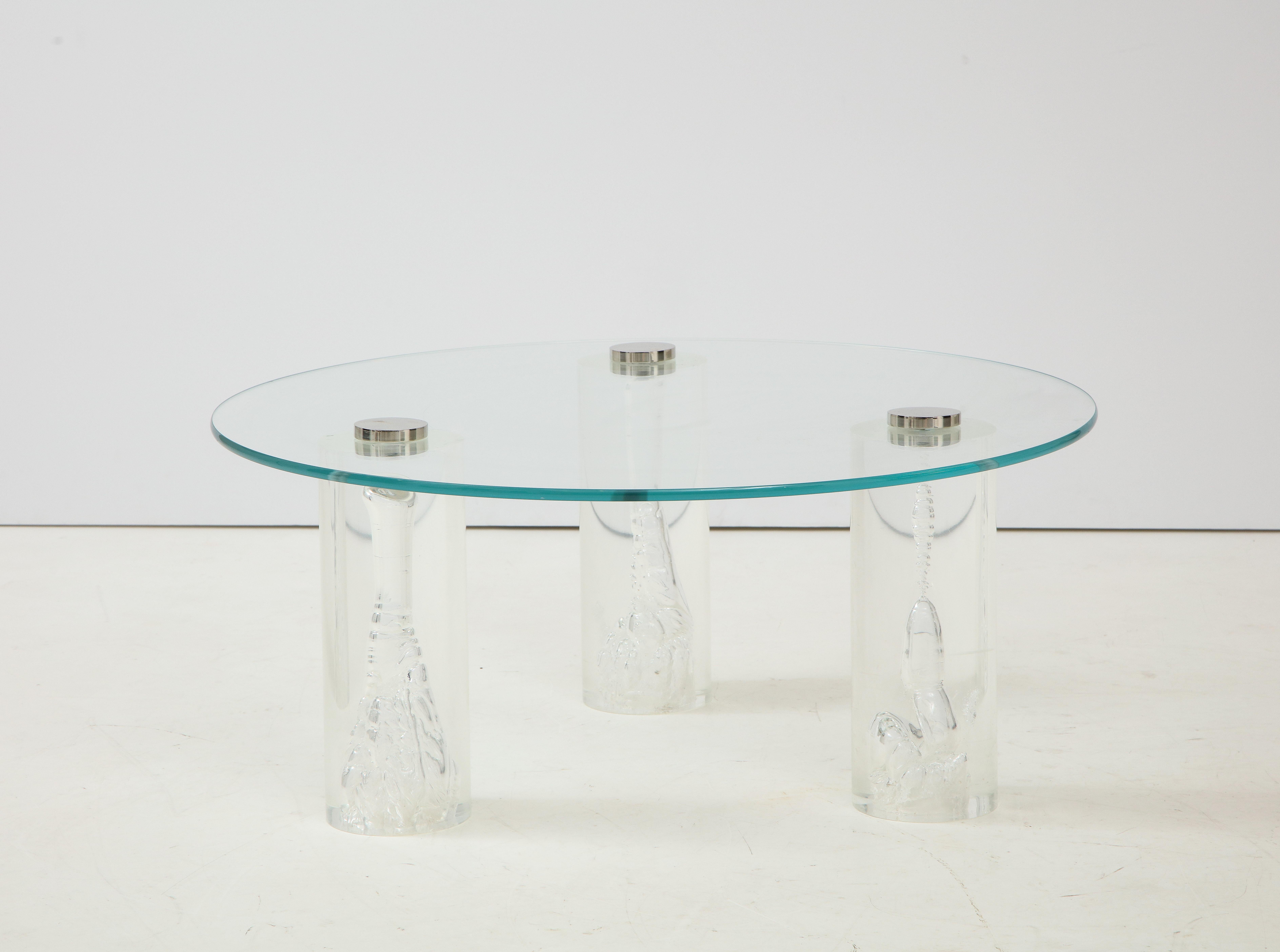 1980's Lucite and glass coffee table.
The lucite columns have wonderful internal bubbles randomly achieved during the 
pouring of the lucite to make each column unique.
Each leg supports the glass top with a polished chrome disc.
