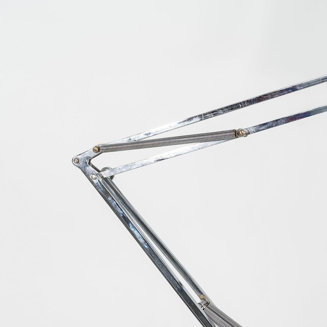 This is a Luxo Lamp, originally designed by Jac Jacobsen in 1937. This particular example was produced by Luxo ASA in Norway circa the 1980s. The lamp is comprised of chrome and features a weighted base. 

The lamp measures 9.5 inches wide at the