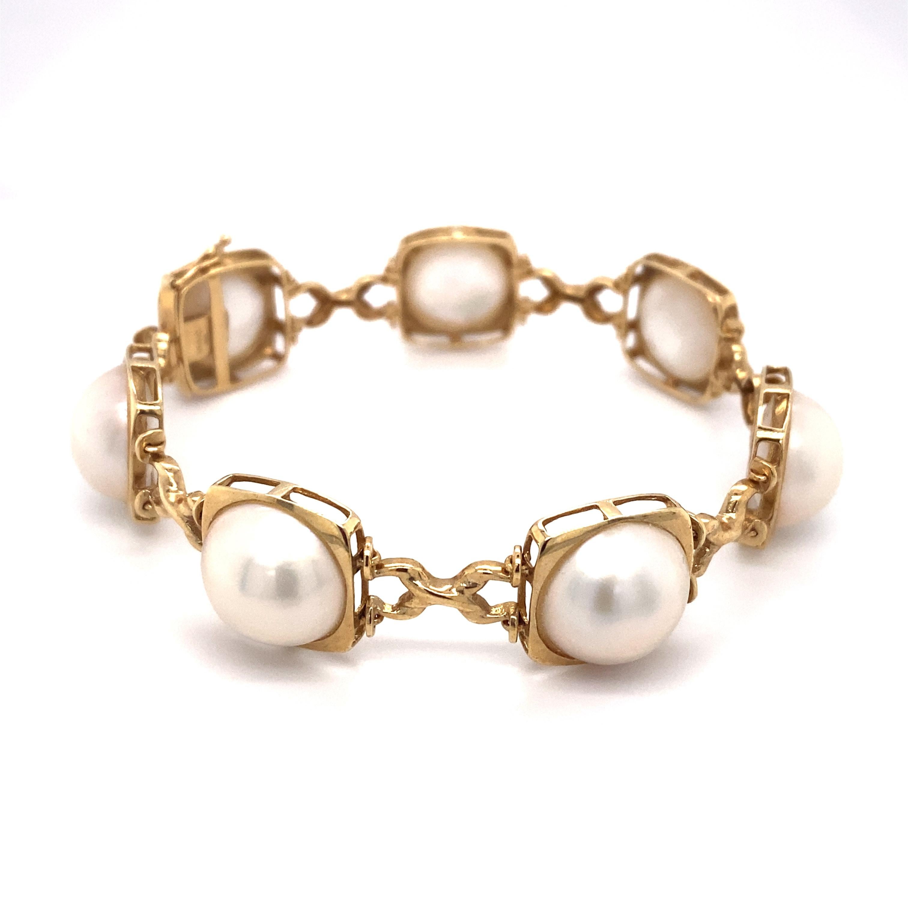 Circa: 1980s
Metal Type: 14 karat yellow gold
Weight: 18.2 grams
Dimensions: 7 inch length x 0.5 inch width 

Pearl Details: 
Mabe Pearl
Size: 12.5mm