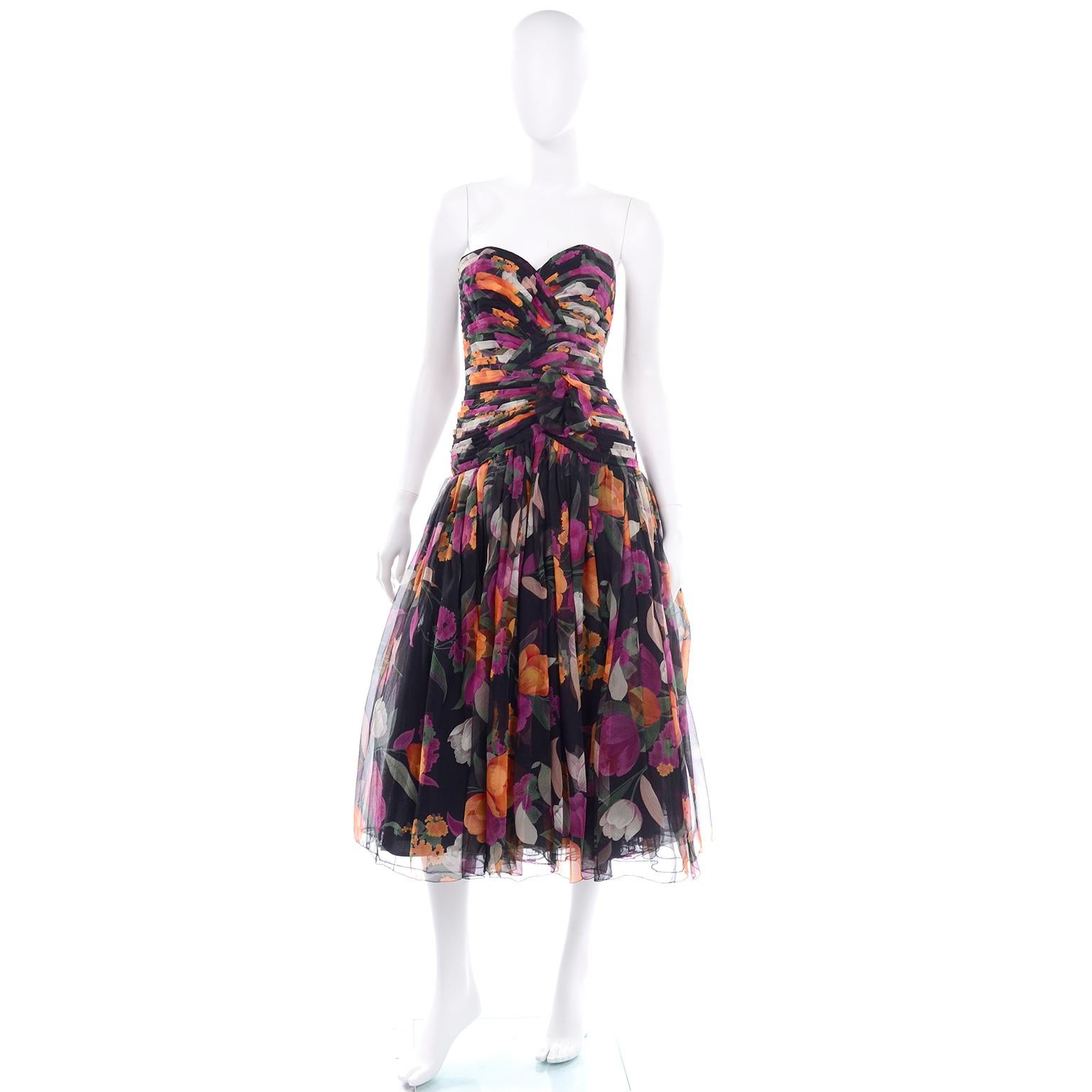 This is an exquisite Saks Fifth Avenue Silk Floral Print Pleated Vintage Strapless Dress.	This gorgeous sweetheart neckline strapless dress is a perfect transitional dress into fall. The colors of the flowers are in very warm tones of orange, pink,