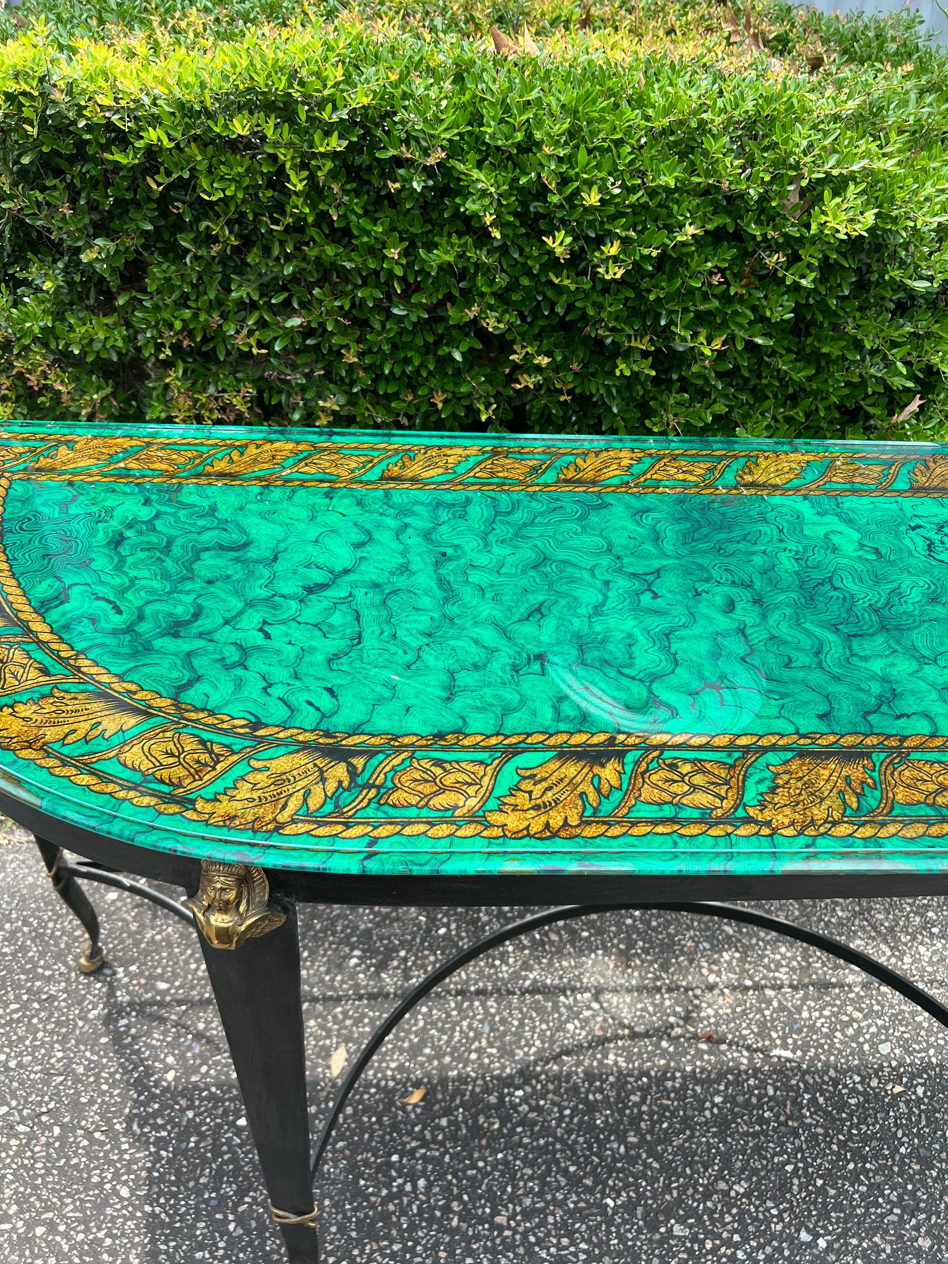 A stunning French empire style/ regency hand painted faux malachite under beveled glass console table.   With gilt ormolus and bronze gilt hoofed feet.   The base is a cross base iron and gilt.
