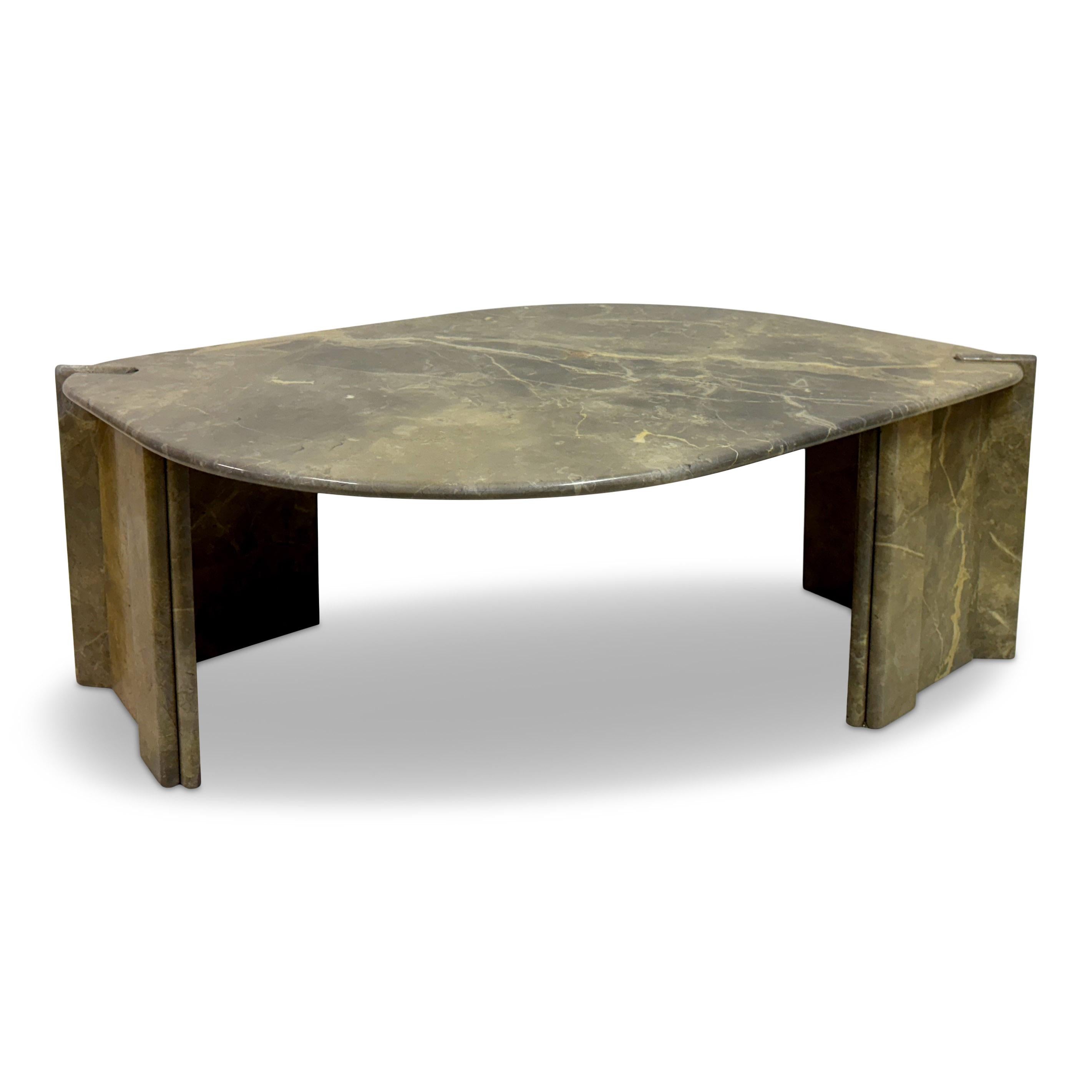 1980s marble coffee table in eye-shaped form

A sculptural marble coffee table from 1980s Italy, striking in both material and silhouette. Its soft, asymmetrical top — suggestive of an eye or a polished river stone — rests on two solid slab legs