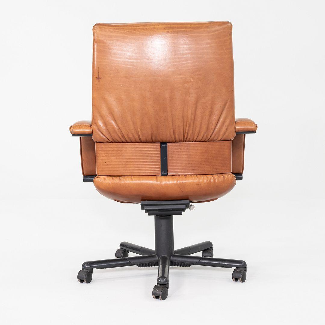 This is a Figura Desk Office Chair, originally designed by Mario Bellini and Dieter Thiel for Vitra in 1979. This example was produced in Germany and dates to the 1980s. The chair features an aluminum base with castors and has a swivel mechanism.