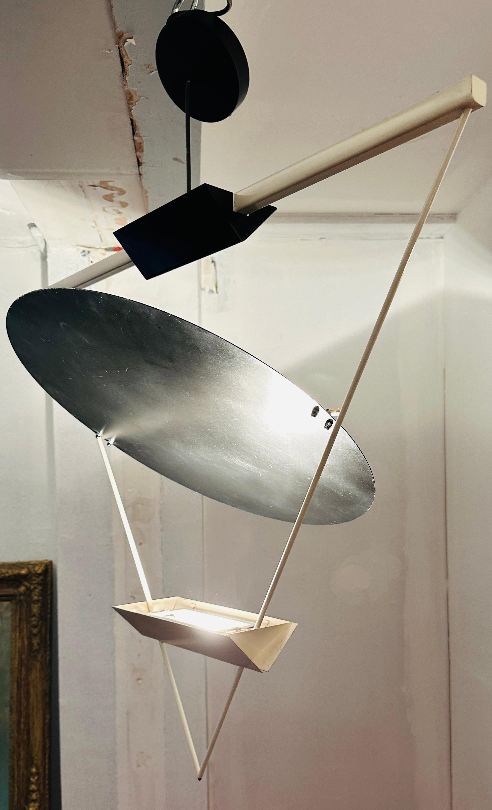 1980s Italian inverted suspended triangular hanging ceiling pendant light designed by Swiss born architect and designer Mario Botta for Italian lighting company Artemide.  A classic design of the era.

An interesting geometric design similar to that