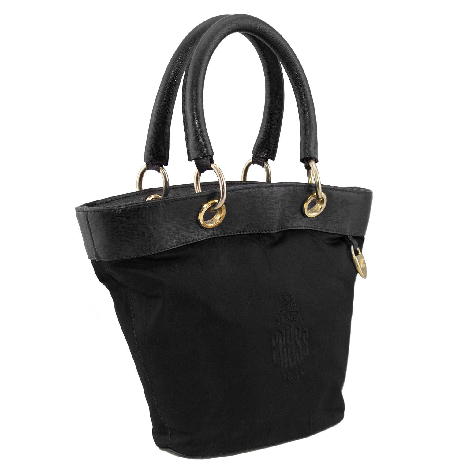 Very cute Mark Cross double handle bucket bag from the late 1980s. Black nylon with Mark Cross logo embroidered at centre front. Black leather handles, trim and base. Contrasting gold tone hardware and small gold MC engraved charm. Black interior