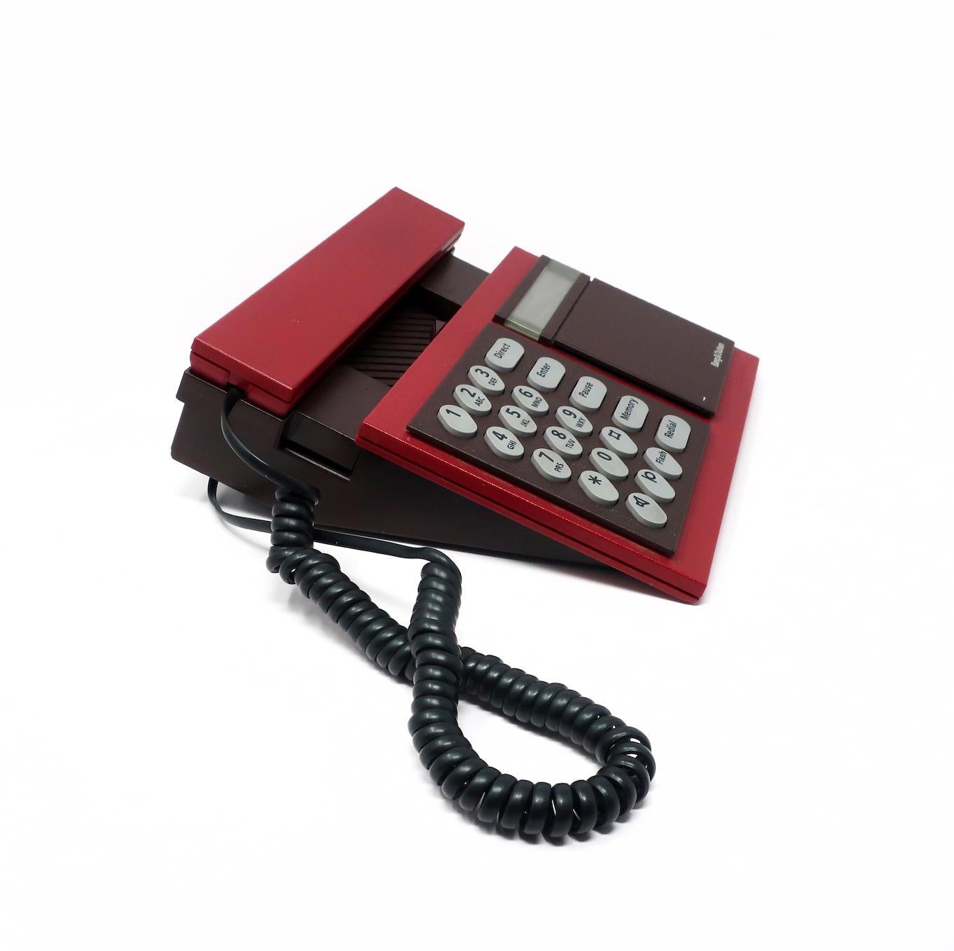 Designed in 1986 Lone and Gideon Lindinger-Lowy, the Bang & Olufsen Beocom 2000 telephone is Danish design at its finest, and the epitome of 1980s high-tech and high design. It has a maroon handset and body and gray buttons.

In good vintage