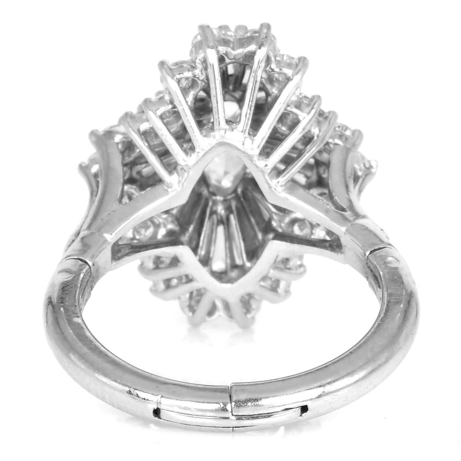 Dazzle with the high sparkle of this pure diamond Cocktail cluster ring.  

They are crafted in Platinum, ballerina style setting, and feature in the center with one marquise-shaped diamond measuring 8.70mm x 4.66 mm x 4.20mm, weighing approx—1.01