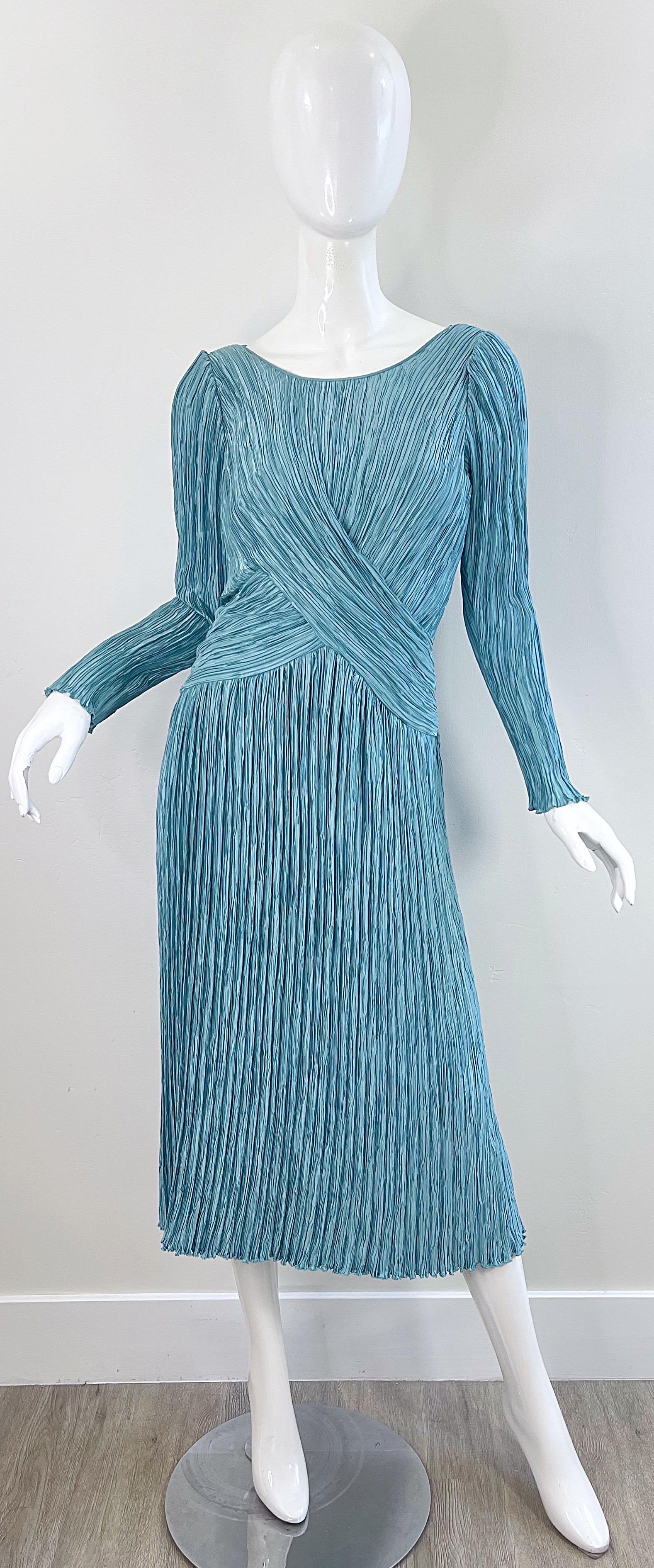 Beautiful and flattering vintage early 80s MARY MCFADDEN COUTURE light blue signature pleated long sleeve dress ! The perfect shade of blue that can be worn anytime of year. Hidden zipper up the side. Tailored bodice with a free flowing skirt. Great