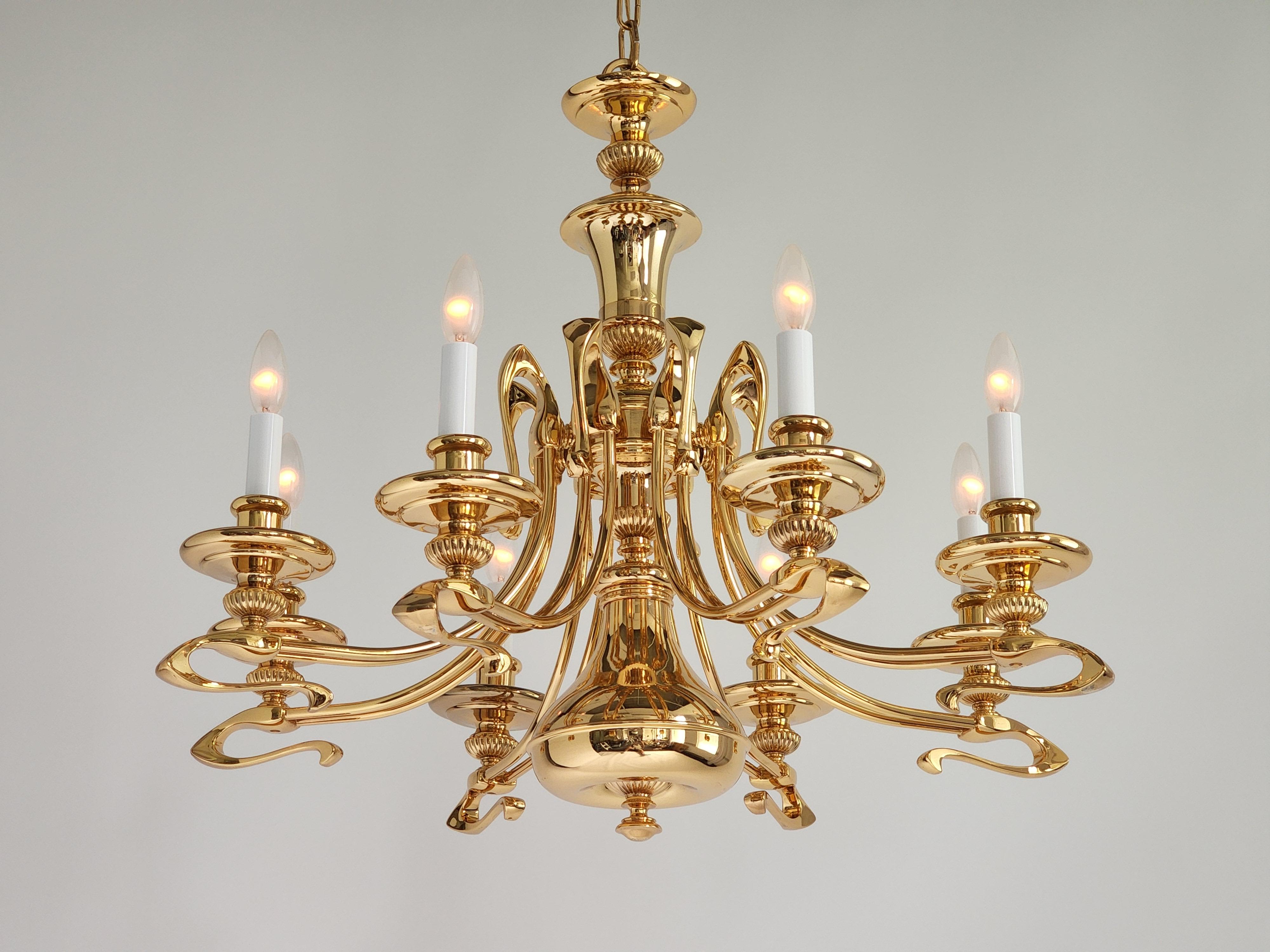 Massive Art Nouveau style chandelier with a classic twist. 

Solid, thick, well made chandelier with a deep gold plated finish. 

8 candelabra size socket rated at 40 watt each. 

32 inches long gold plated chain with matching canopy.
