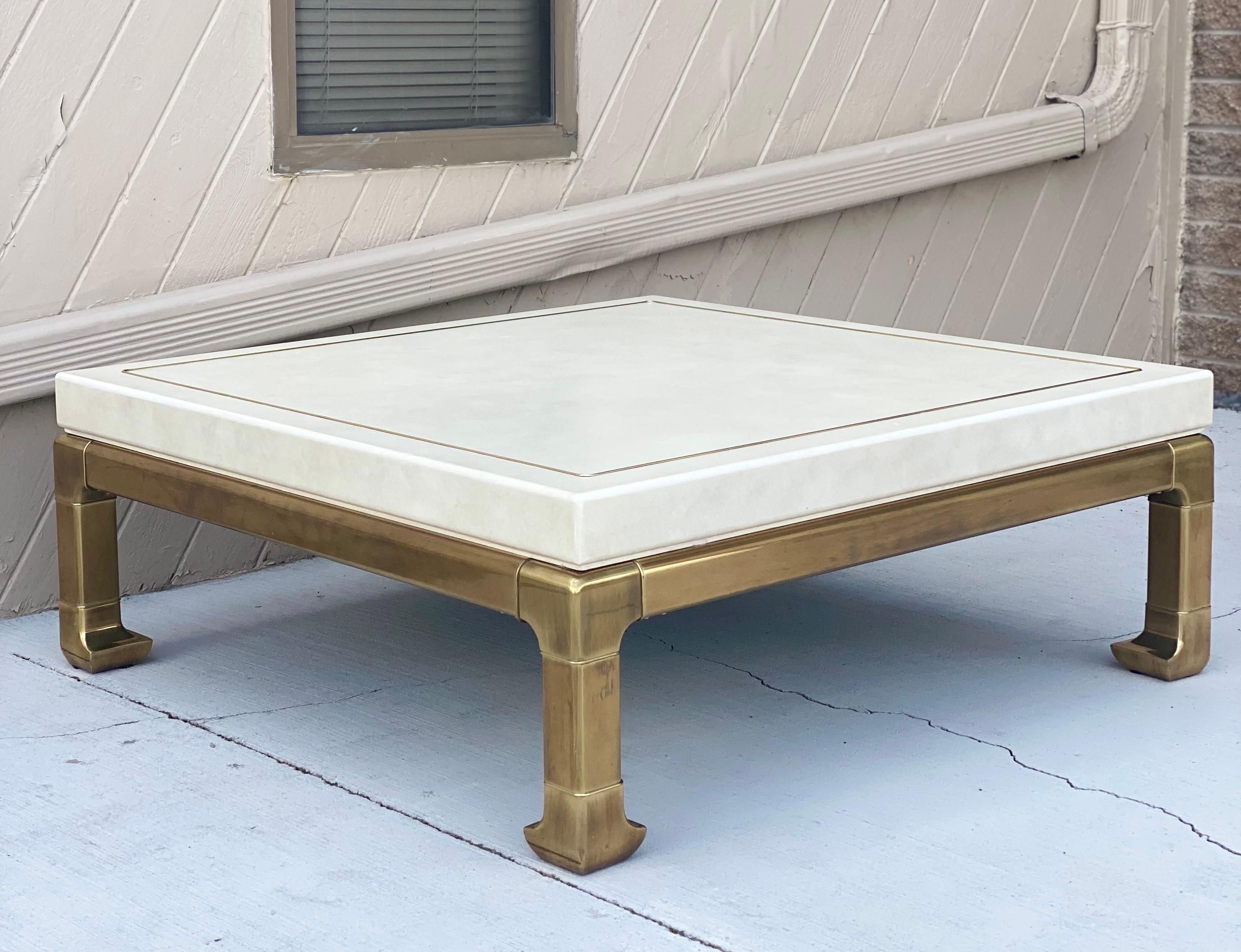 We are very pleased to offer a stunning, conversational coffee table attributed to Mastercraft, circa the 1980s. Wrapped in an ivory leather finish and showcasing a brass inlaid, this piece is sure to add lots of texture. In true Ming-style fashion,