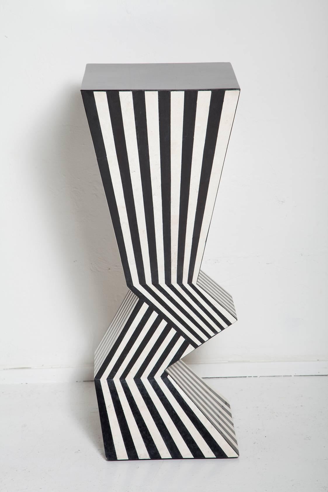Drawing inspiration from the boldly graphic style of the Memphis-Milano group, this 1980s pedestal in black and natural tessellated stone is an artwork unto itself.