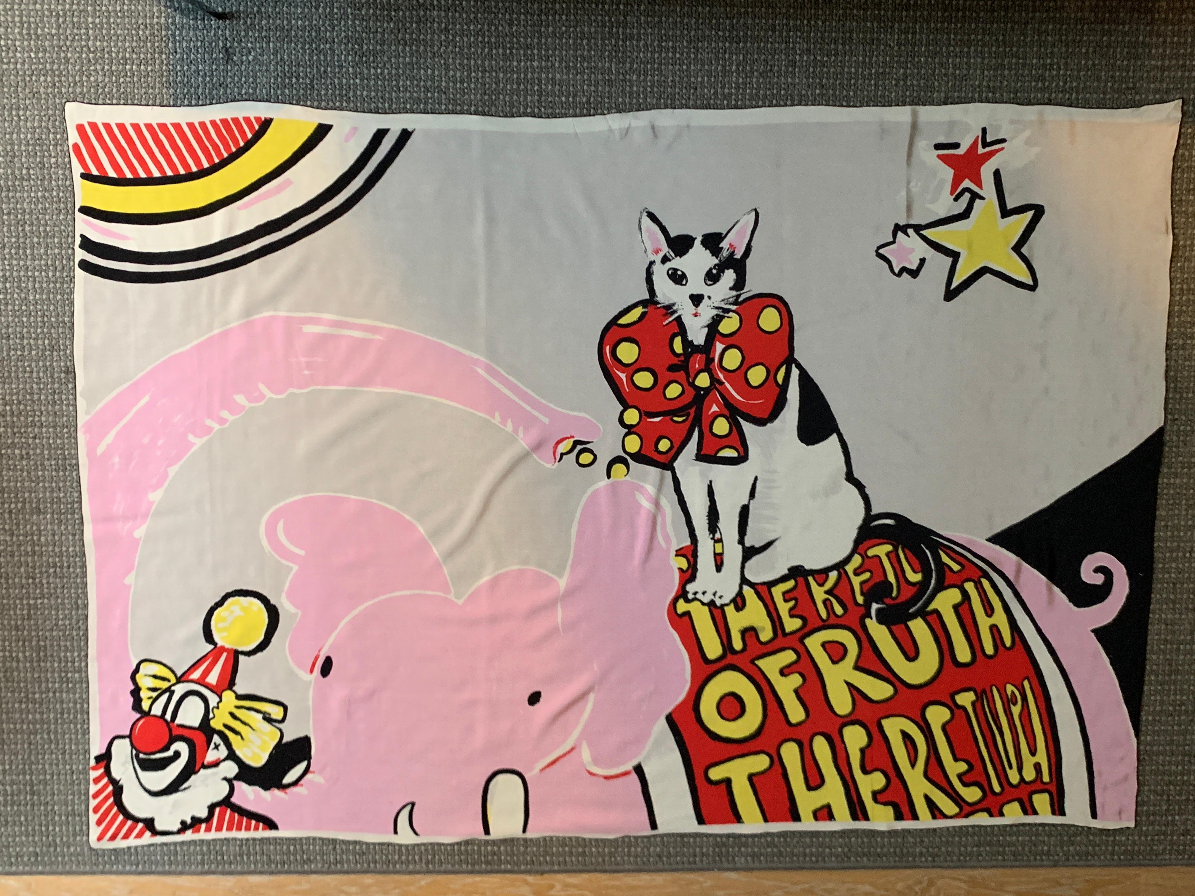 Huge Michael Vollbrach vintage scarf or sarong featuring his iconic mascot,  Ruth the Cat. In this whimsical illustration, Ruth the Cat is seen at the circus riding a pink elephant with a big banner reading 
