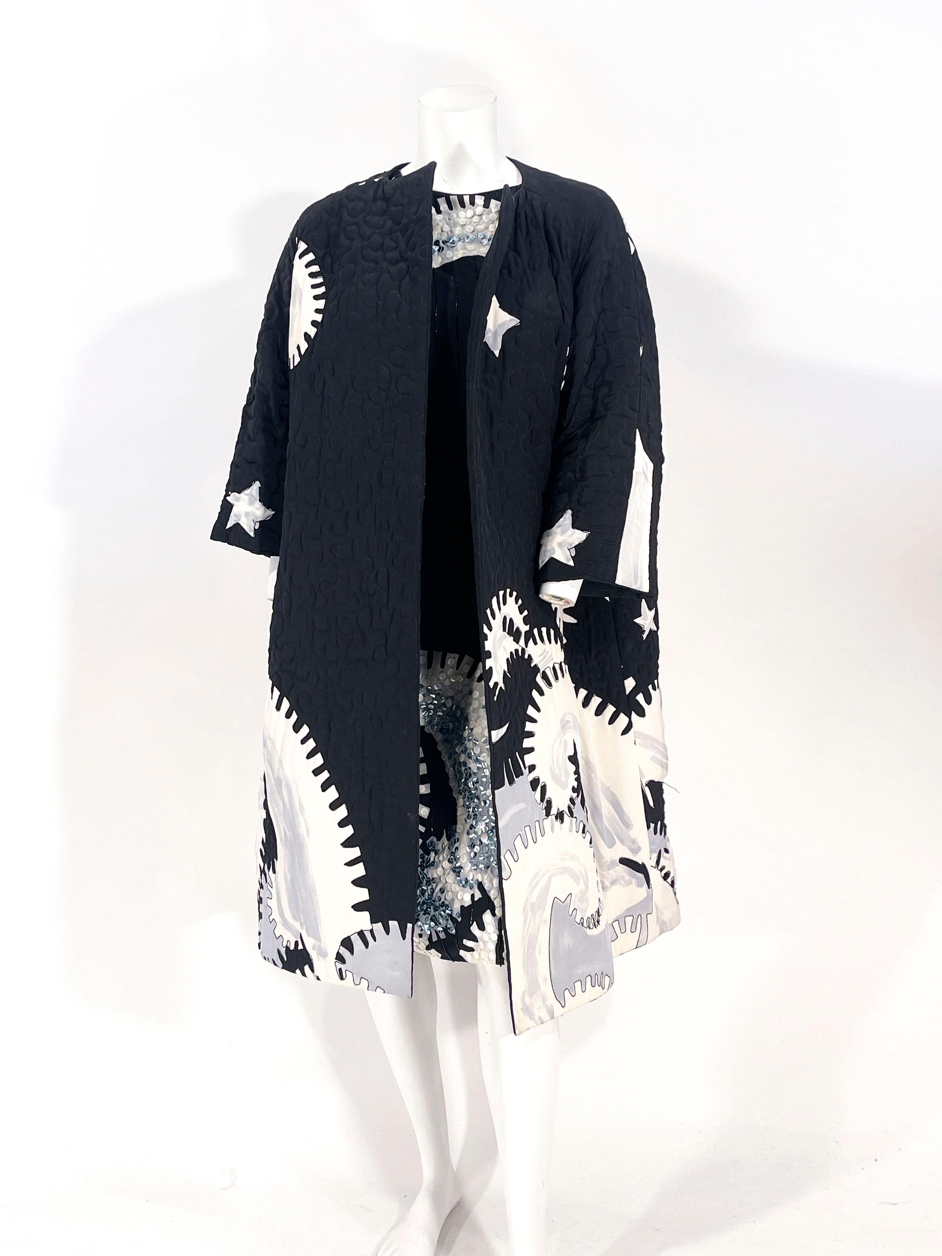 1980s Michaele Vollbracht coat and dress ensemble, both of which are featuring an abstract painterly print in black white grey and blue tones. The straight waisted and sleeveless dress has accent beading and sequin to accentuate the printed