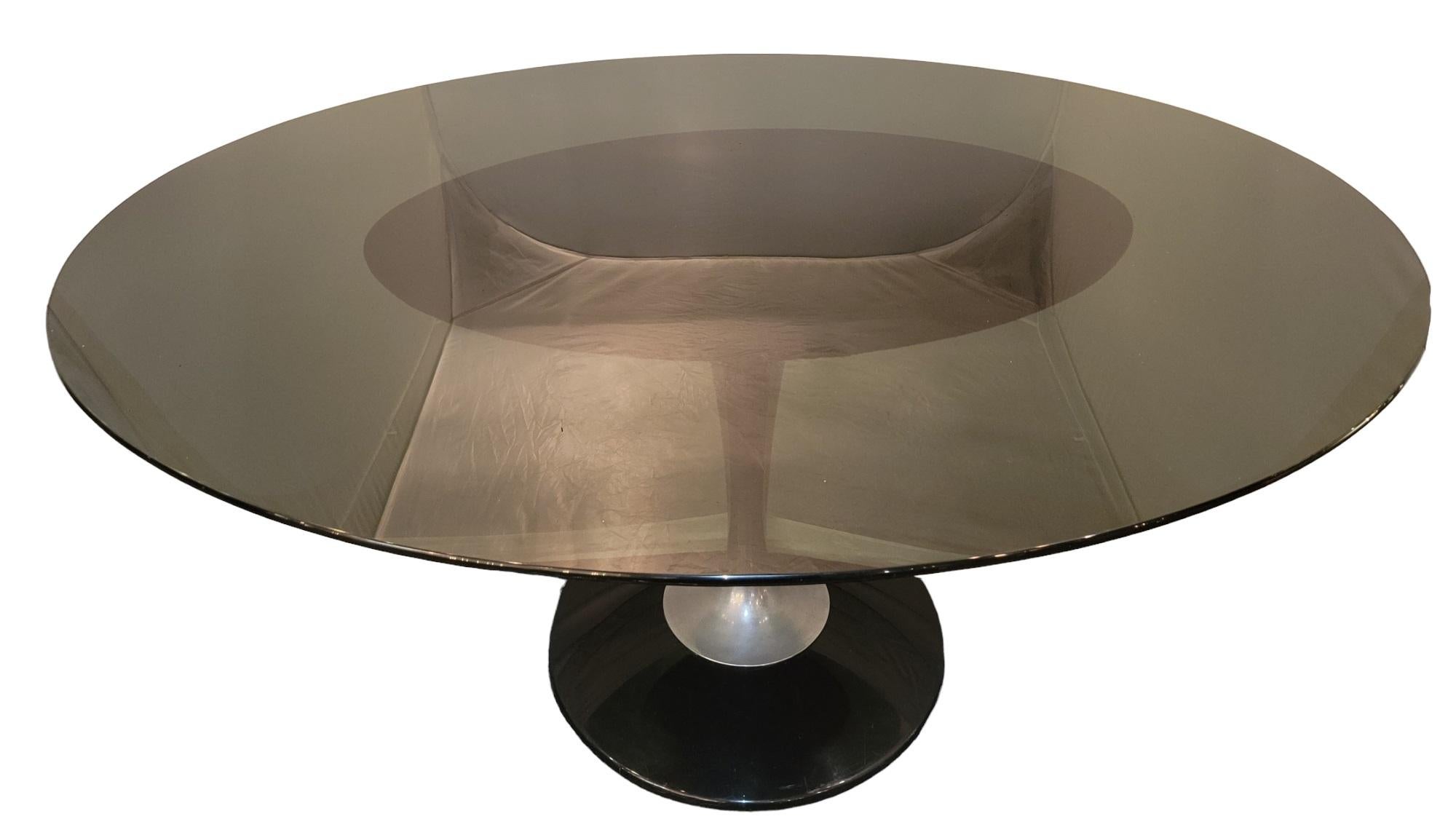 Midcentury glass and metal pedestal dinning/ conference table is a metal base with a leather top for the oval glass top to rests on.
Measures approx - 60w x 46d x 29 high.