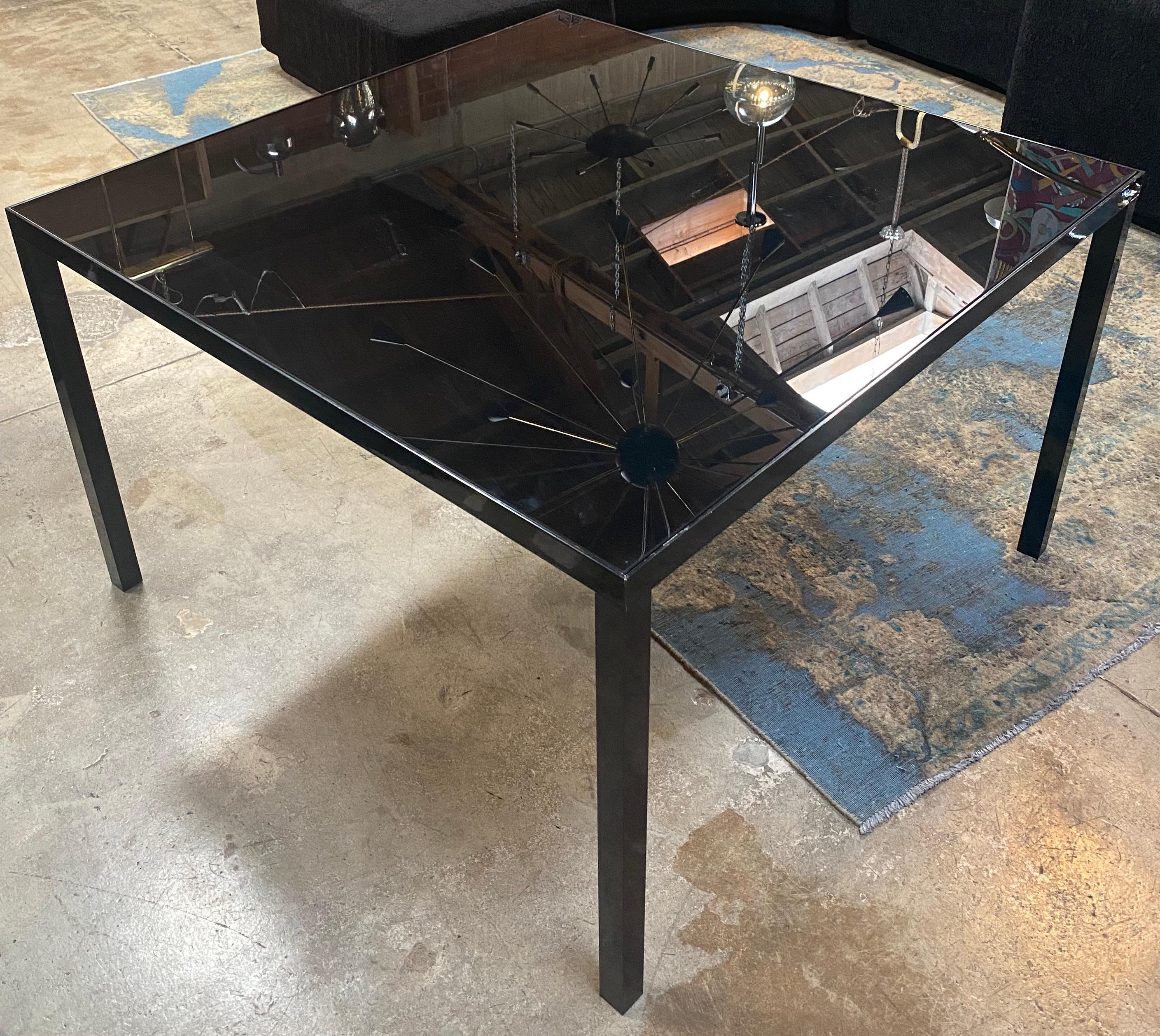 Beautiful Italian metal and glass top dining table. The table is in very good conditions and present minor use. Nothing touches, nothing clashes, which gives this piece of furniture a completely peaceful yet strong expression. A piece like this will