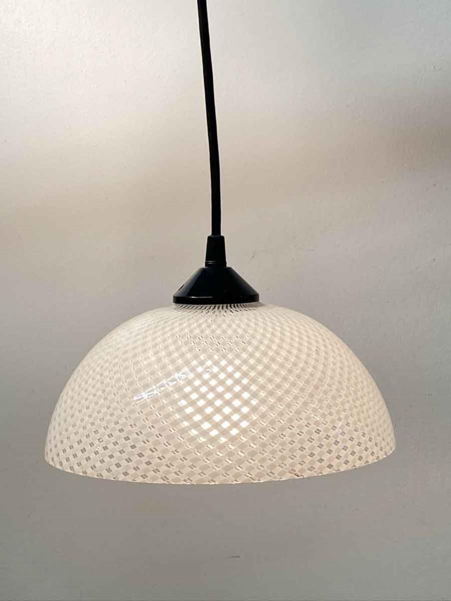1980s Mid-Century Modern style hand blown white and clear Vetri Murano glass shade fitted with a black cord to make a petite pendant light. Made in Italy. Price includes restoration. This can be seen at our 400 Gilligan St location in Scranton. PA.