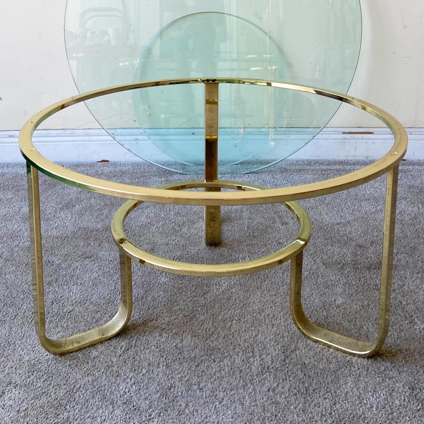 Amazing Mid-Century Modern two tier circular coffee table. Features a gold frame a two circular glass tops.
 