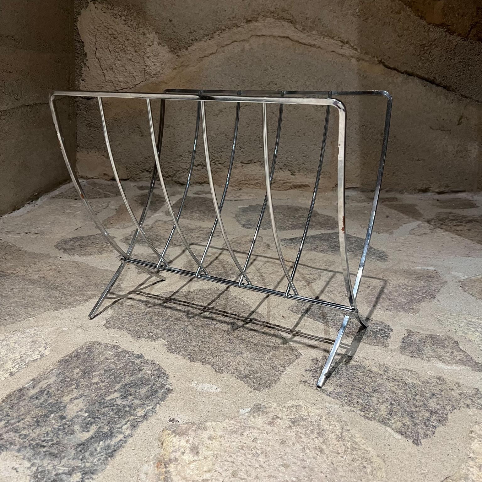 1980s Mid-Century Modern Streamlined Chrome Magazine Rack Foldable
Clean modern lines. Chrome plated finish.
No stamp 
13.25 h x 15.25 w x 10 d and Folded 16 x 3.25
Some areas have pitting on chrome.
Preowned unrestored vintage condition.
refer to