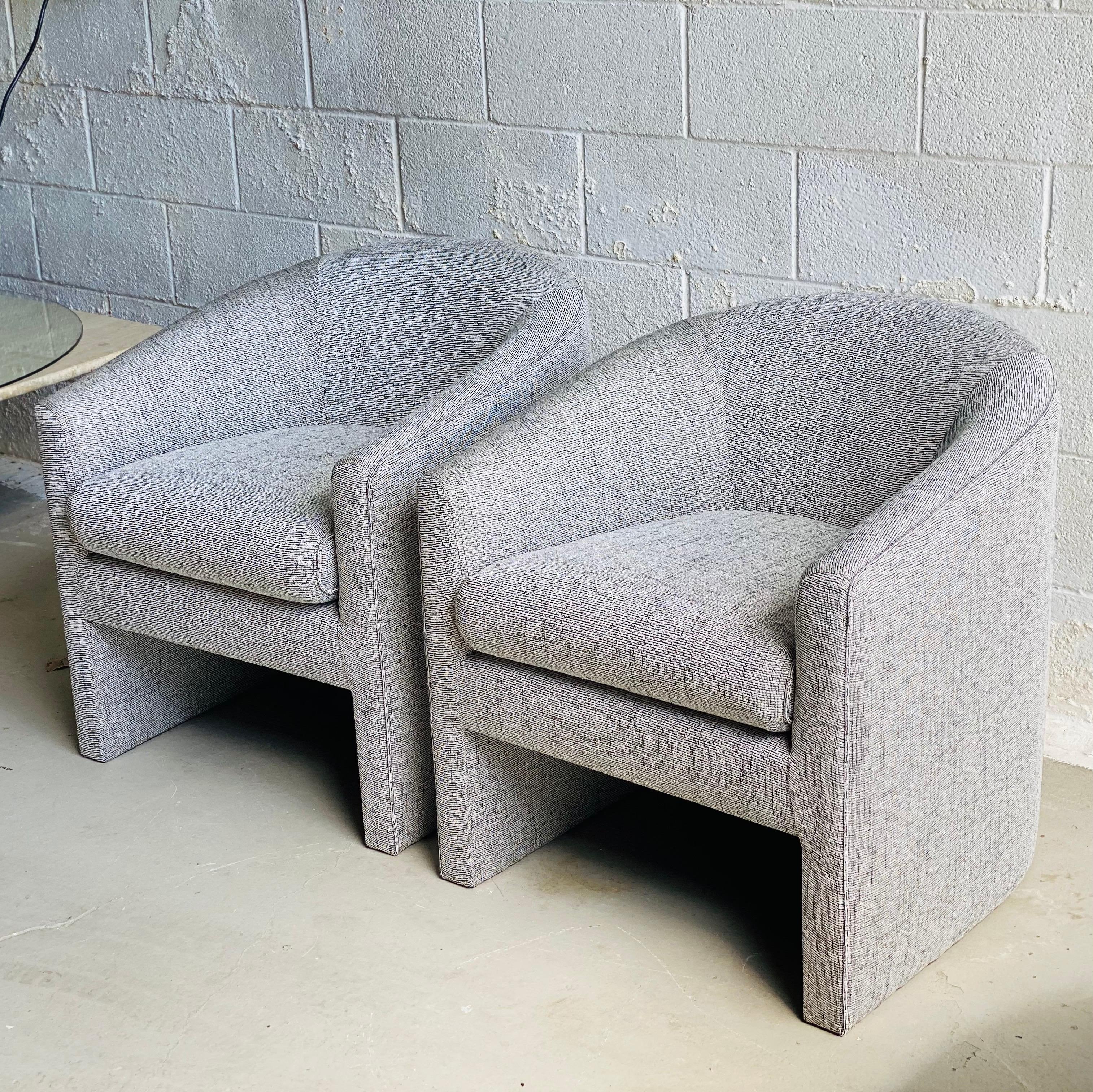 We are very pleased to offer a gorgeous set of barrel chairs in the style of Milo Baughman, circa the 1980s. This fabulous set is newly reupholstered in a salt and pepper Herman Miller fabric; additionally, chairs feature new cushions. With its