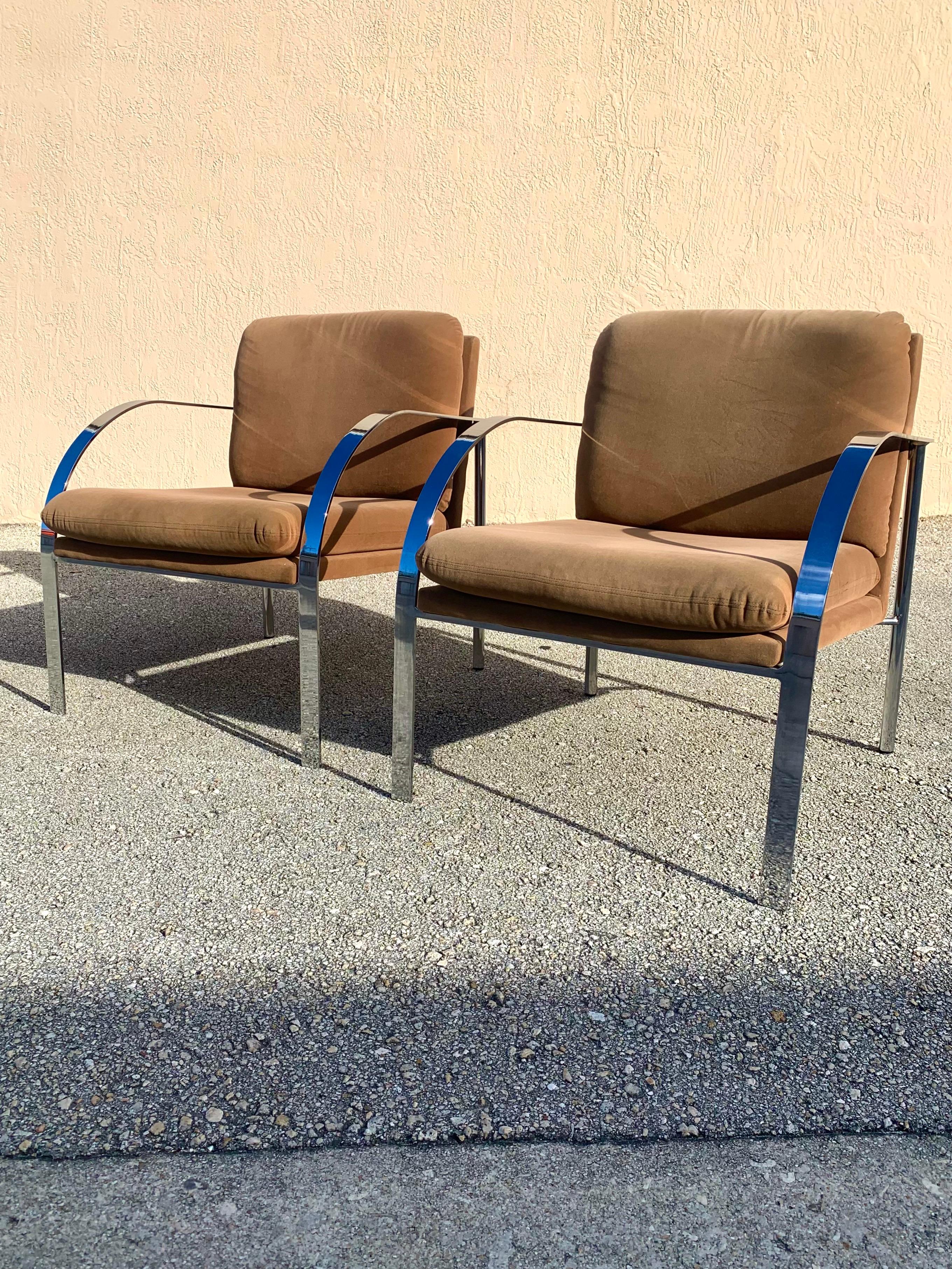 Pair of Mid-Century Modern flat bar chrome lounge chairs. With flat chrome arms and round supports. Chairs have a lovely flowing design. Made very well with the chrome being welded together rather than the screw together pieces manufactured today.