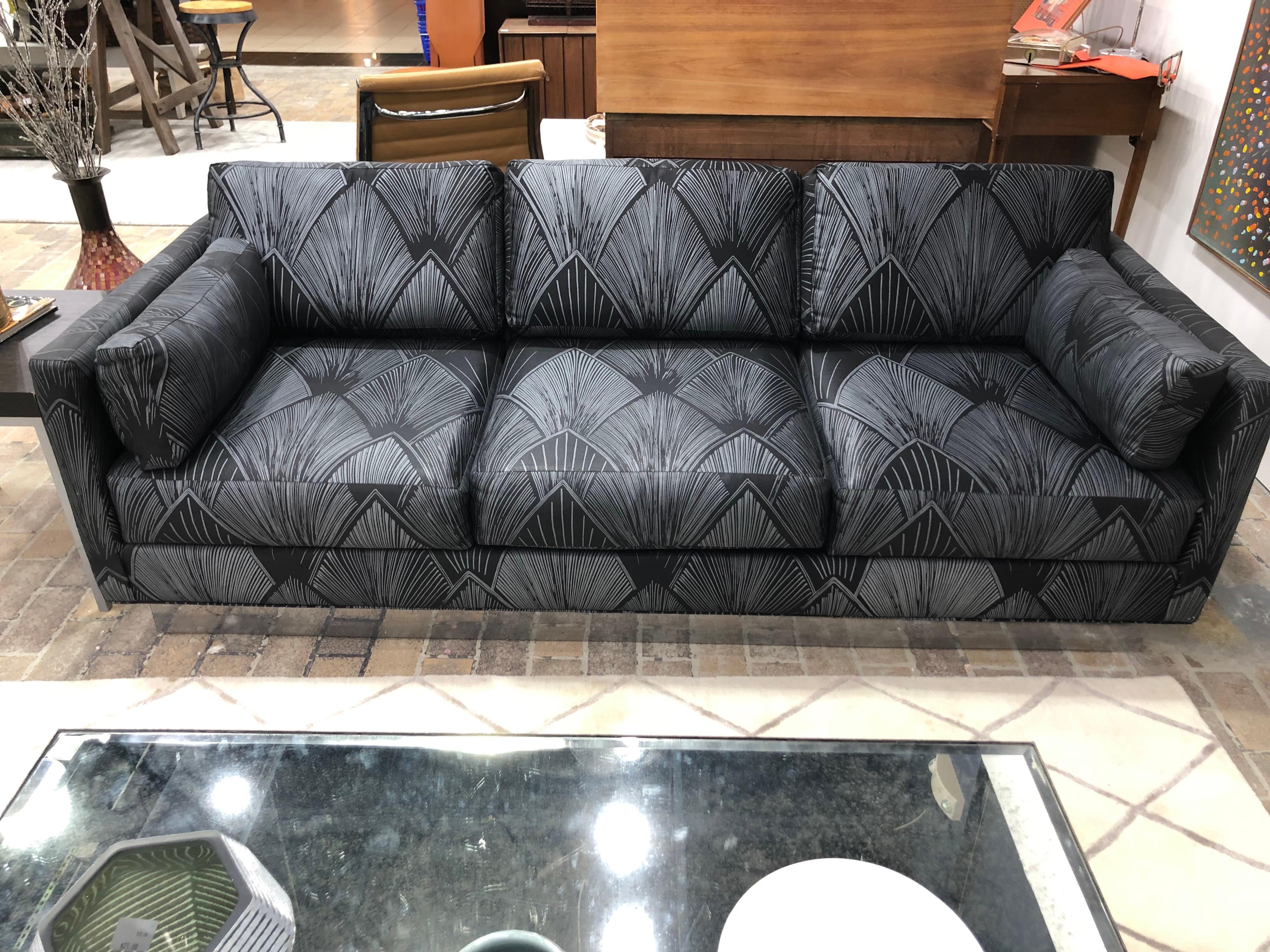 1980's Milo Baughman Style black sofa with chrome base. This stunning piece was barely used and is in impeccable condition. Perfect for that spacious high end nyc apartment. Firm pillows and cushions make up this well made tuxedo style sofa. Its
