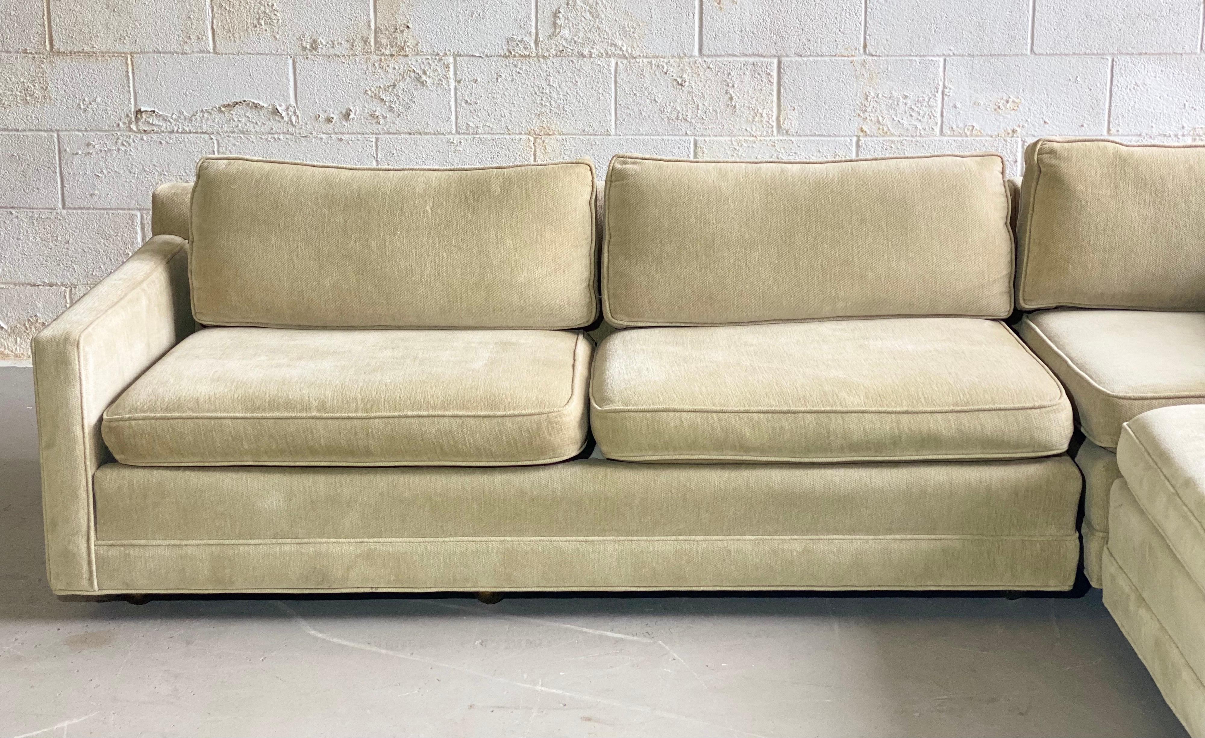 We are very pleased to offer a stylish, yet comfortable sectional in the style of Milo Baughman, circa the 1980s. This L-shape cornering sofa features slim arms, clean Mid-Century lines and unparalleled comfort. Tailored in an off-white wheat