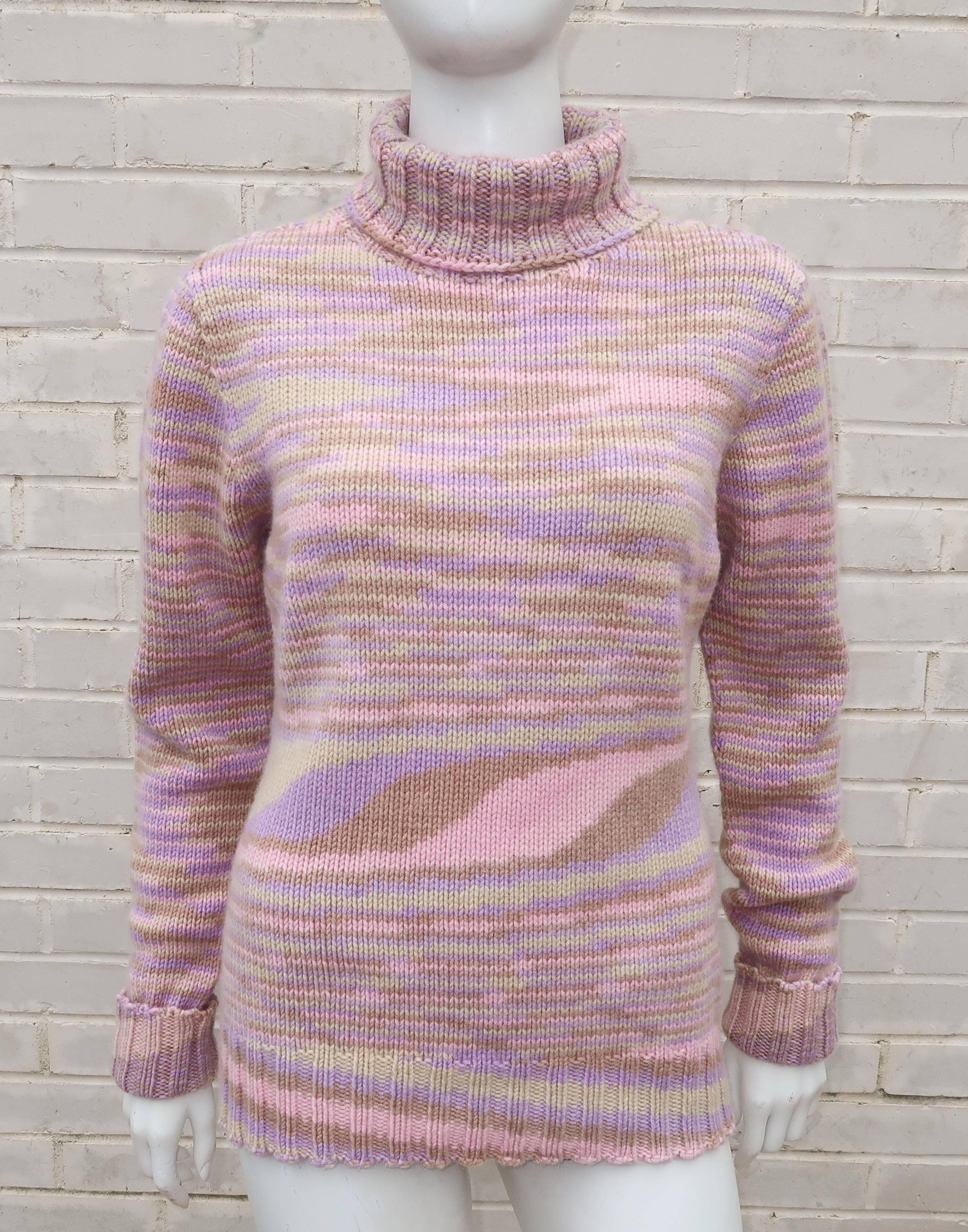 This 1980’s Missoni turtleneck sweater is a tactile combination of cozy cashmere and subtle op art design.  The pastel color palette of pink, beige, lilac and sage green is mixed into a horizontal striped pattern with dips and curves in unexpected