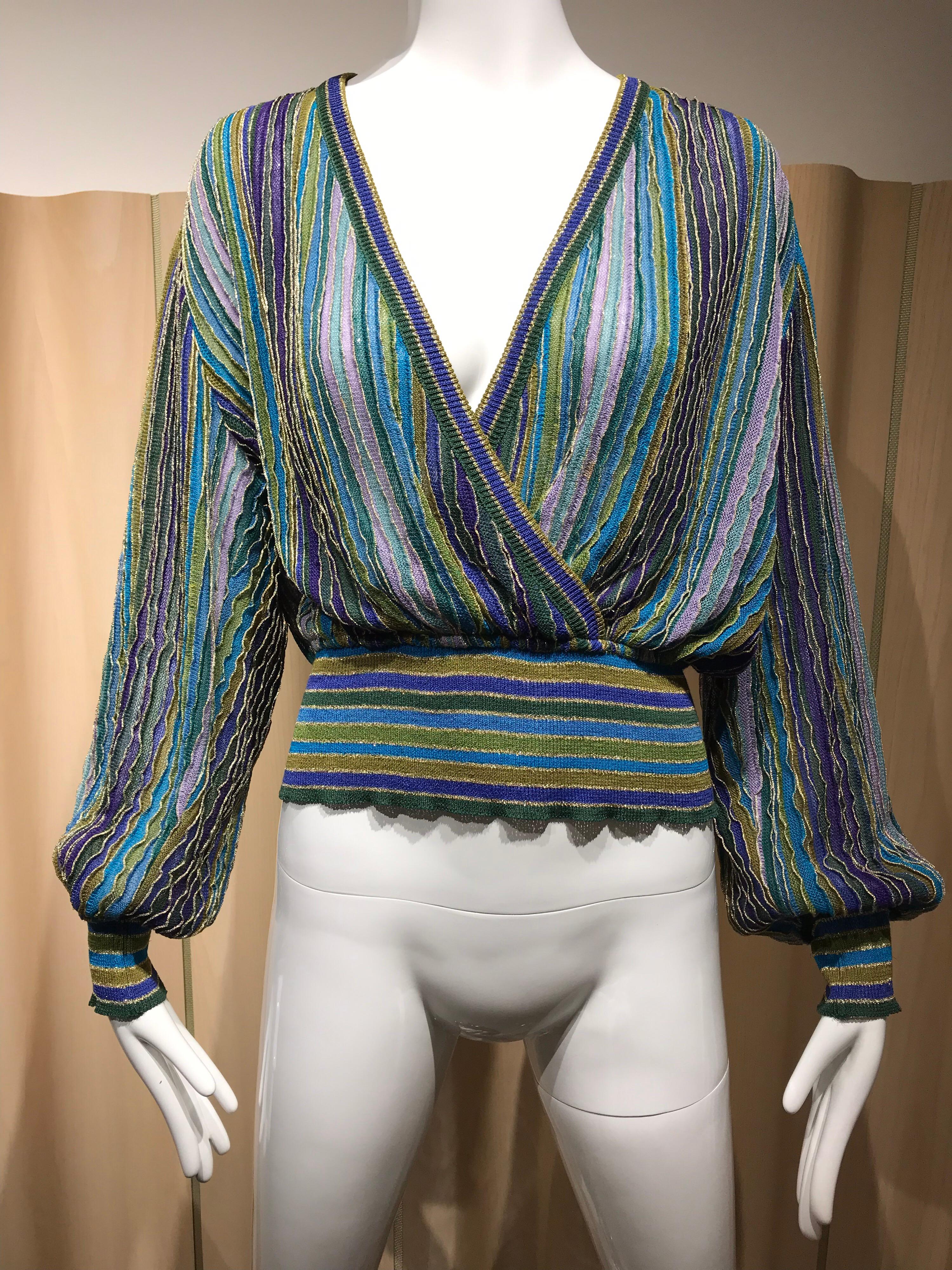  1980s Missoni Teal blue and Purple Metallic Knit Long Sleeve Top and Skirt set.
Long Sleeve V Neck Sweater knit top with elastic waist and Wrap Skirt.
Fit size 6/8
Top Measurement: Bust: 44 / Waist 26 inch  stretch to 32 / Sleeve : 24 inch
Skirt