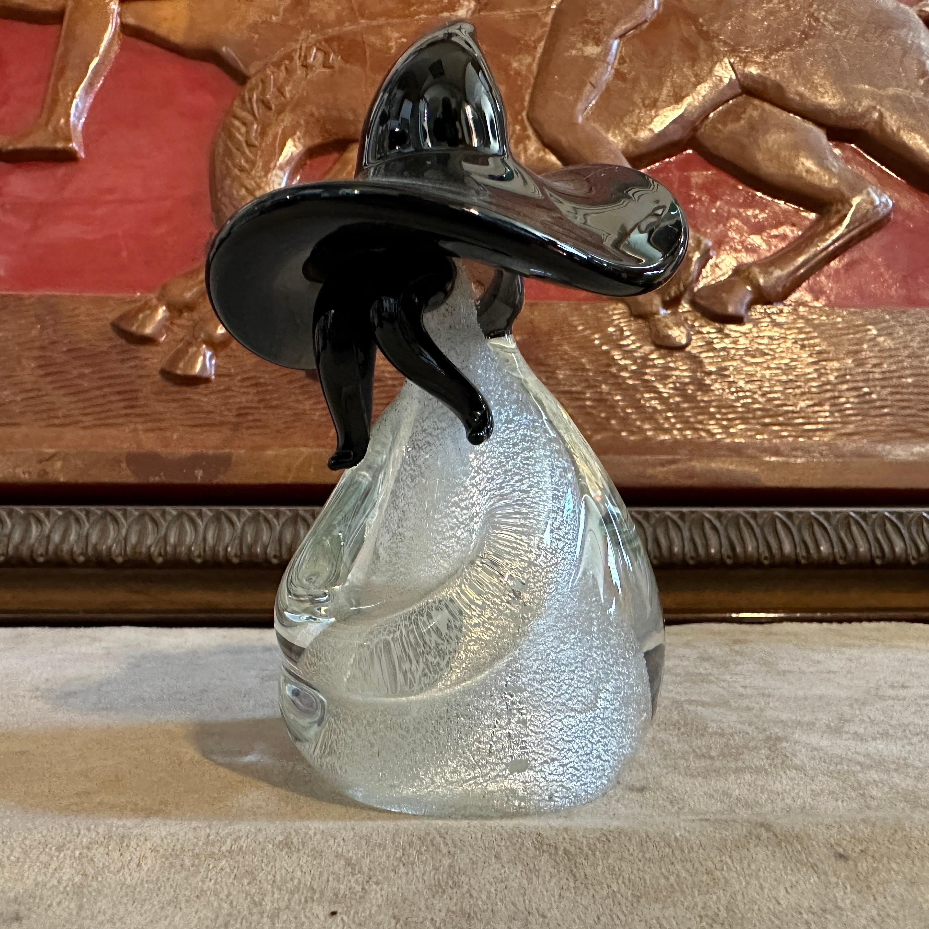 This glass figure of a Mexican is a striking piece of artistry, combining the traditional craftsmanship of Murano glassmaking with a modern aesthetic and cultural representation. The figure depicts a Mexican individual, characterized by their