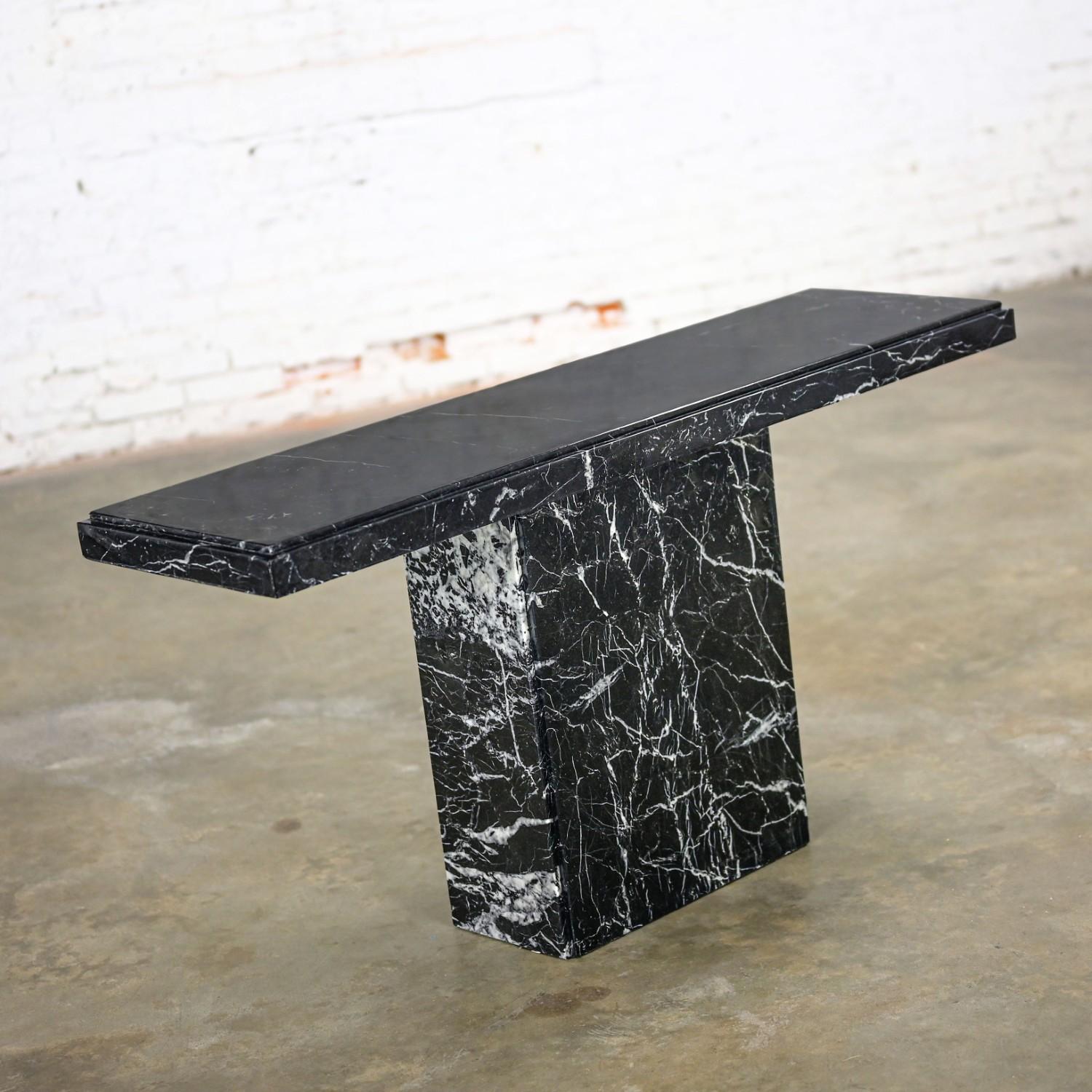 Magnificent vintage black & white (with a touch of gray) marble slab pedestal base sofa or console table in the style of Ello. Beautiful condition, keeping in mind that this is vintage and not new so will have signs of use and wear even if it has
