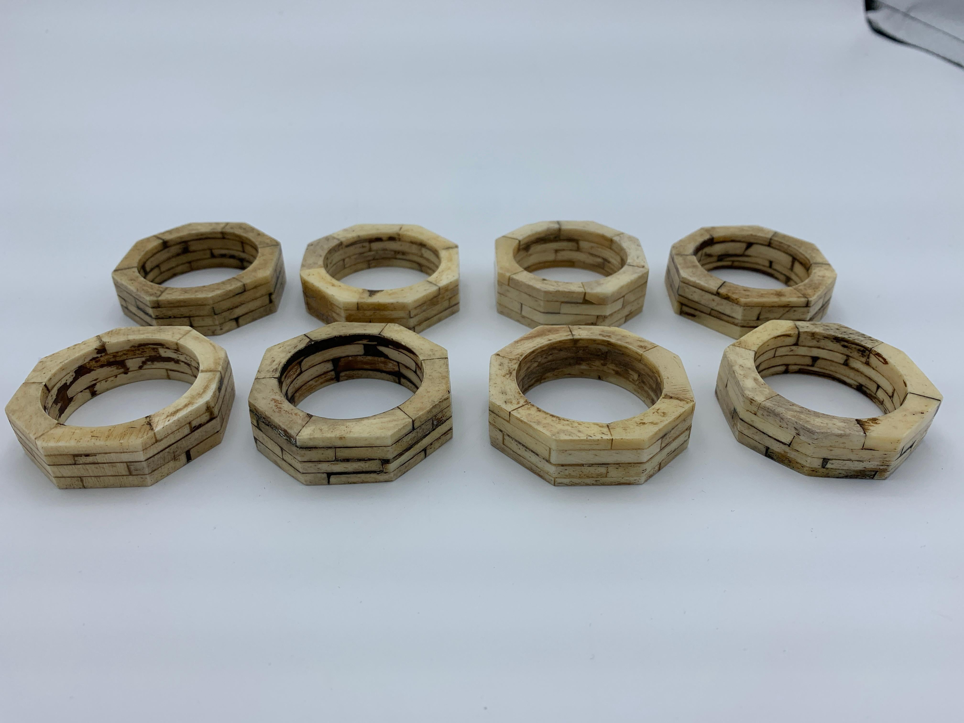 Listed is a sophisticated and modern, set of 8, 1980s bone napkin rings in an octagonal shape. Each napkin ring has been created in a stacked/staggered form, please see photo 7 for reference.