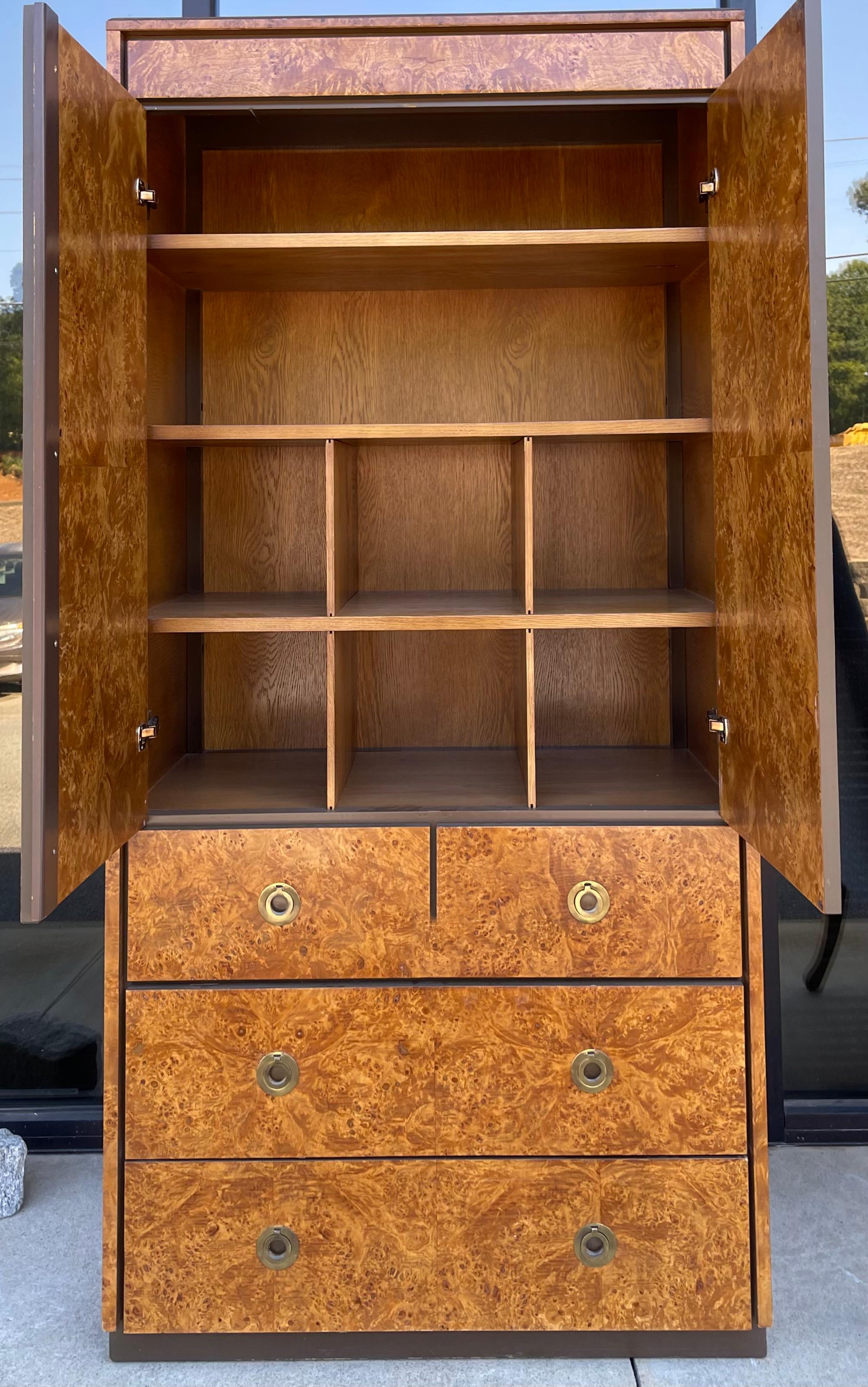 This is a 1970s modern burl wood gentleman’s armoire by John Stuart. It is in very good condition, and it is marked in the drawer. It does have dovetail construction as well.