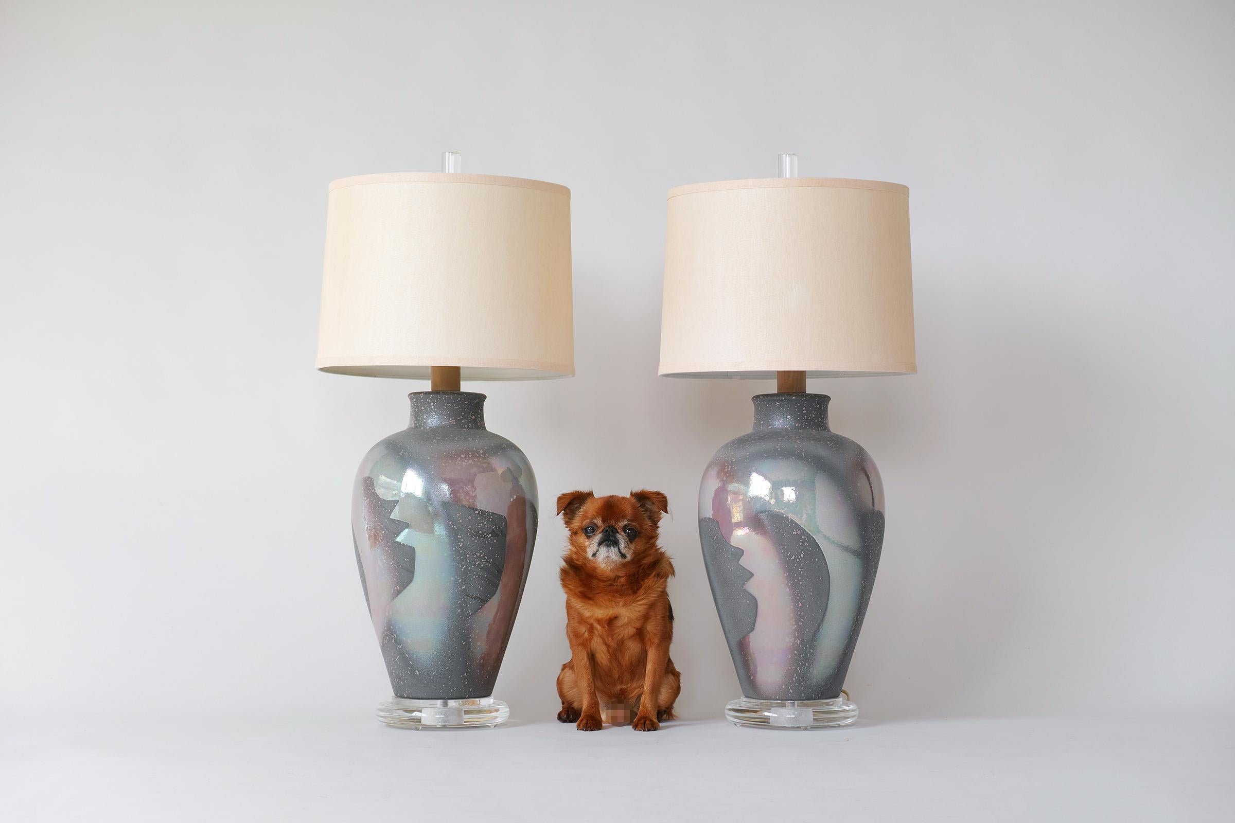 For your consideration is this fine pair of 1980s hand-glazed ceramic lamps by Casual Lamps of California. The ceramic bases are in great condition and feature a matte gray base glaze over which is an iridescent splatter & stencil in muted
