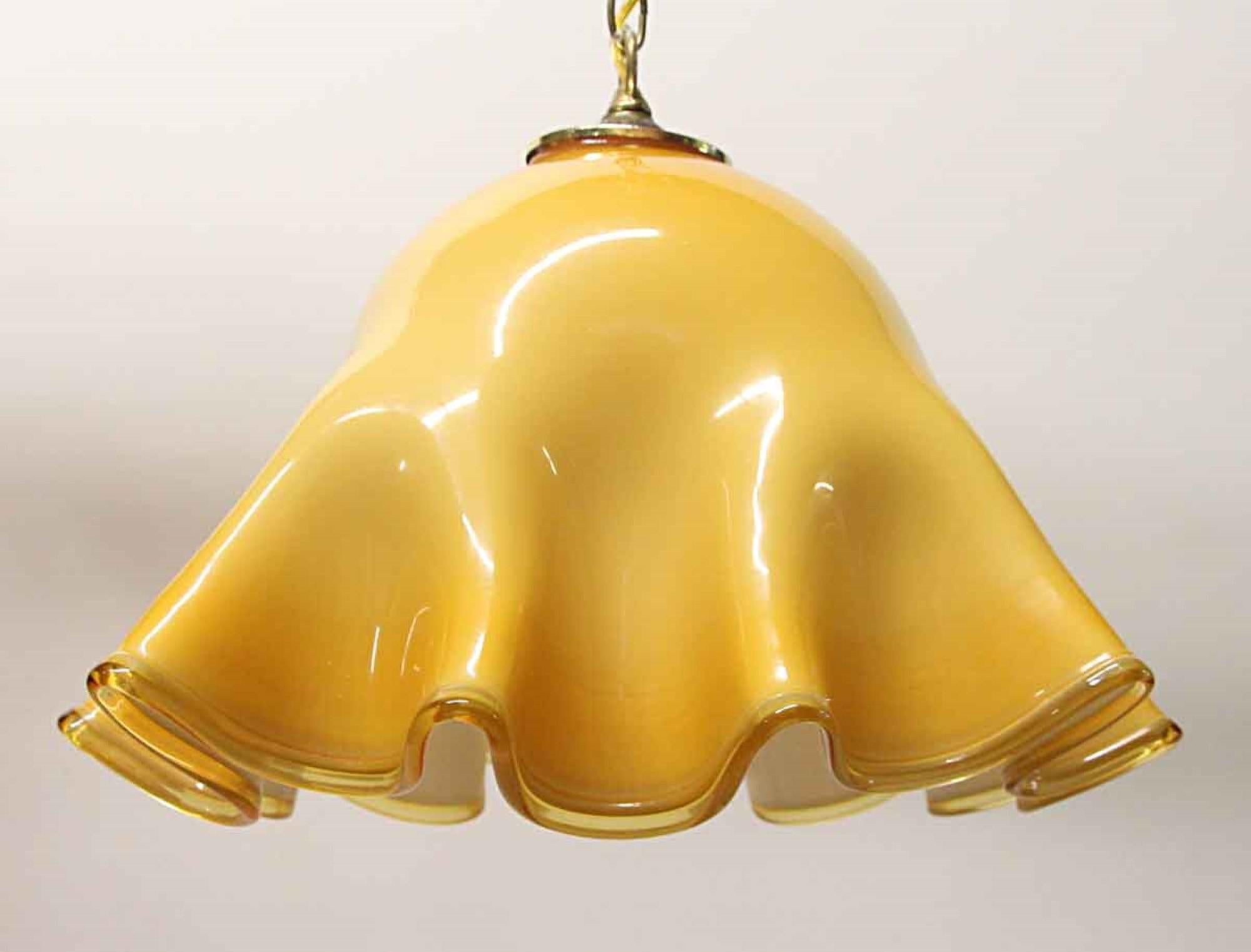 Modern yellow Murano glass ruffled brass pendant light. Comes with brass hardware. This can be seen at our 400 Gilligan St location in Scranton, PA.