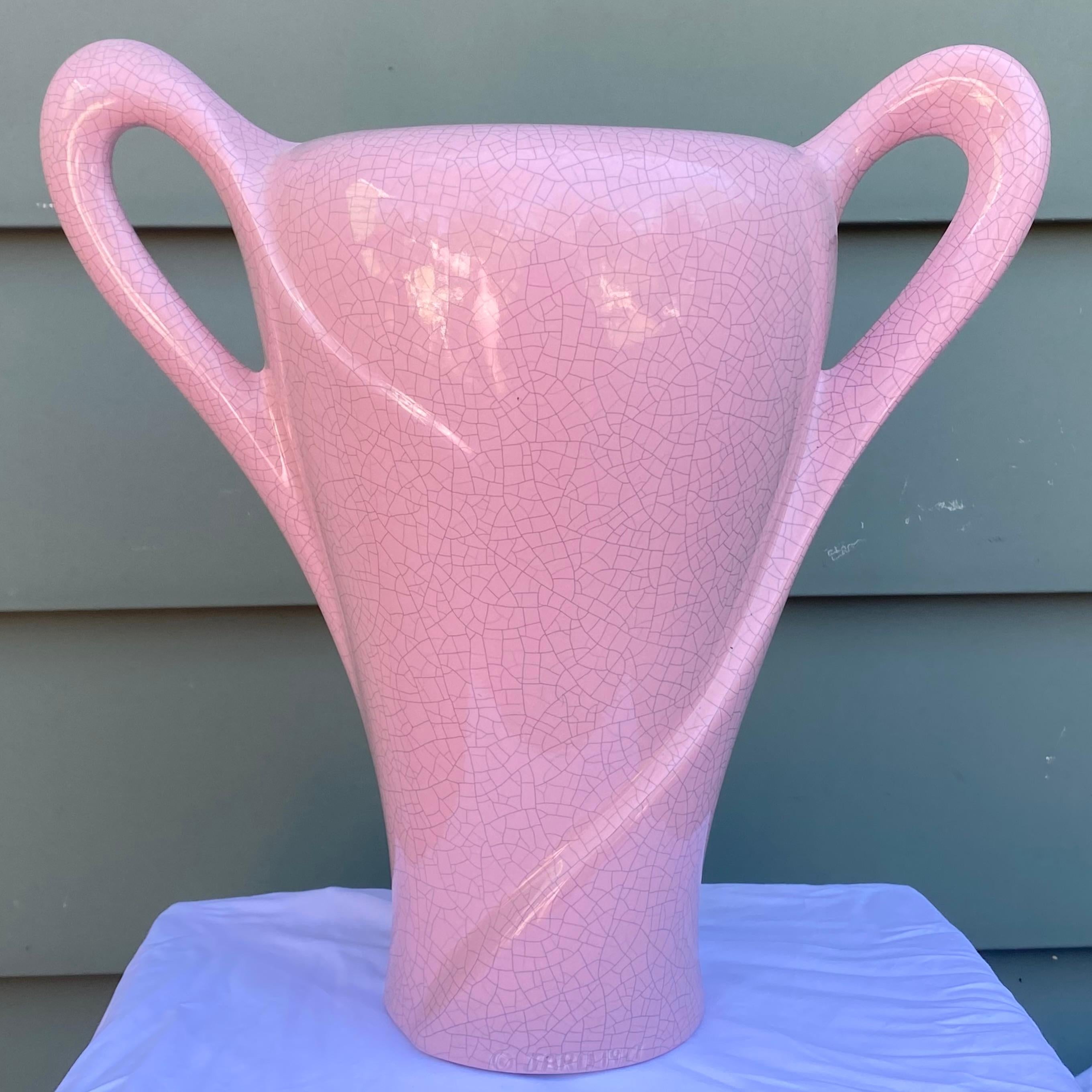 A fantastic artisan made two-handled sculptural ceramic vase fired in a pink crackle glaze finish by the California pottery company Jaru.