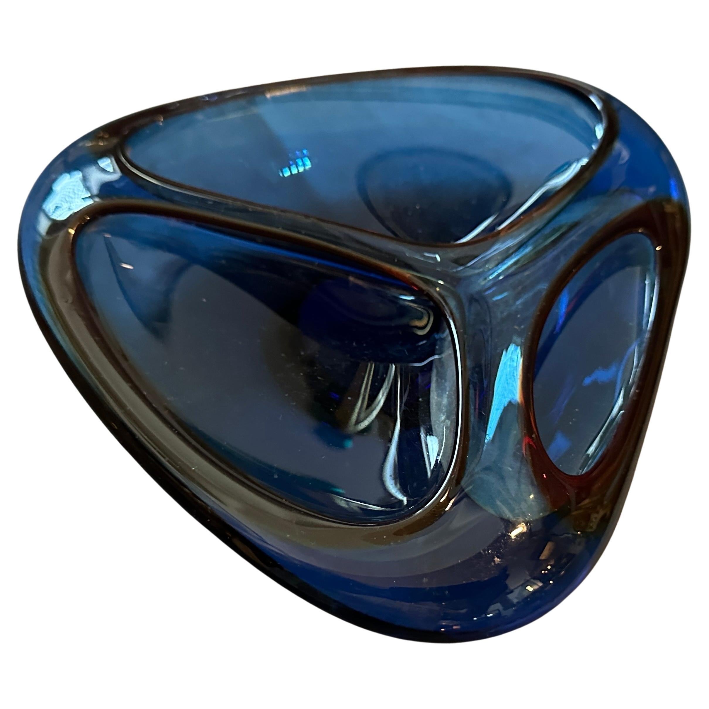 A perfect condition blue and brown murano glass ashtray manufactured in Venice in the Eighties. The Triangular Ashtray is a beautifully crafted and visually striking piece. Its unique shape, vibrant colors, and high-quality Murano glass make it both