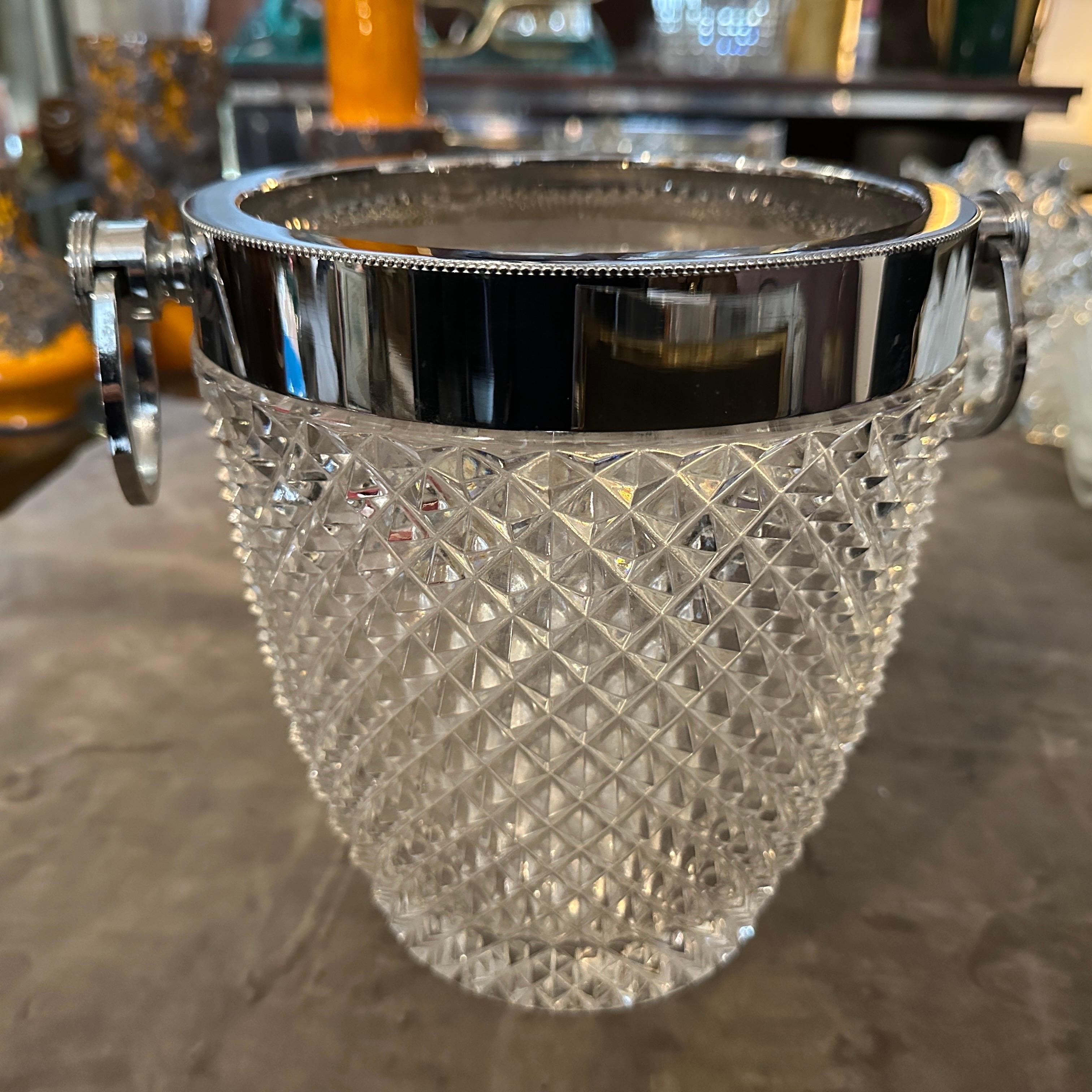 This 1980s Modernist French wine cooler is an elegant blend of luxury and functionality. It features a stunning heavy crystal body with a textured diamond-cut pattern, which enhances its brilliance and allows light to reflect beautifully. The