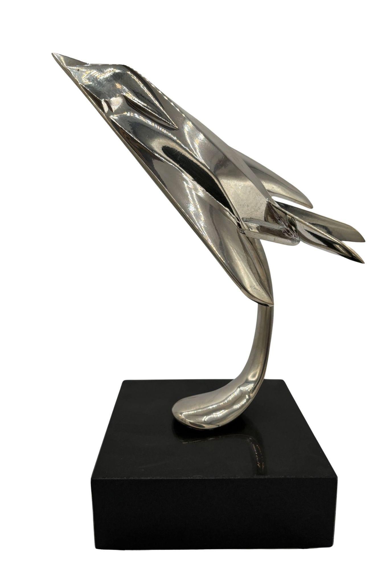 Striking chrome-plated steel sculpture of the famous Lockheed F-117 Nighthawk stealth jet fixed to a black onyx-colored granite base. The sculpture captures the stealth of the legendary aircraft that dominated the news and pop culture of the