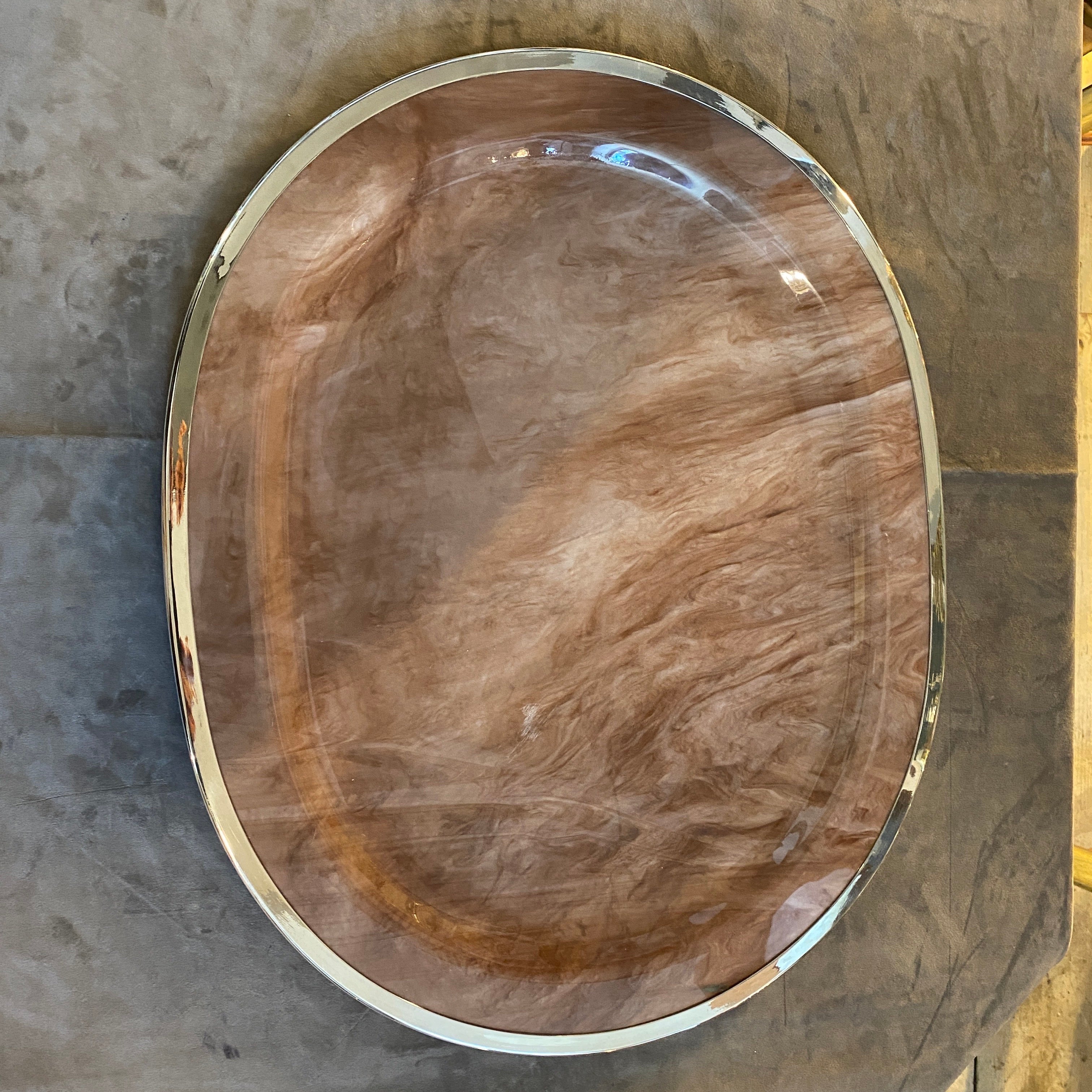 This Oval Tray by B & B Genova embodies the spirit of its era, combining modernist aesthetics with luxurious materials to create a visually striking and functional piece of decor, it  showcases a unique fusion of contemporary design elements and