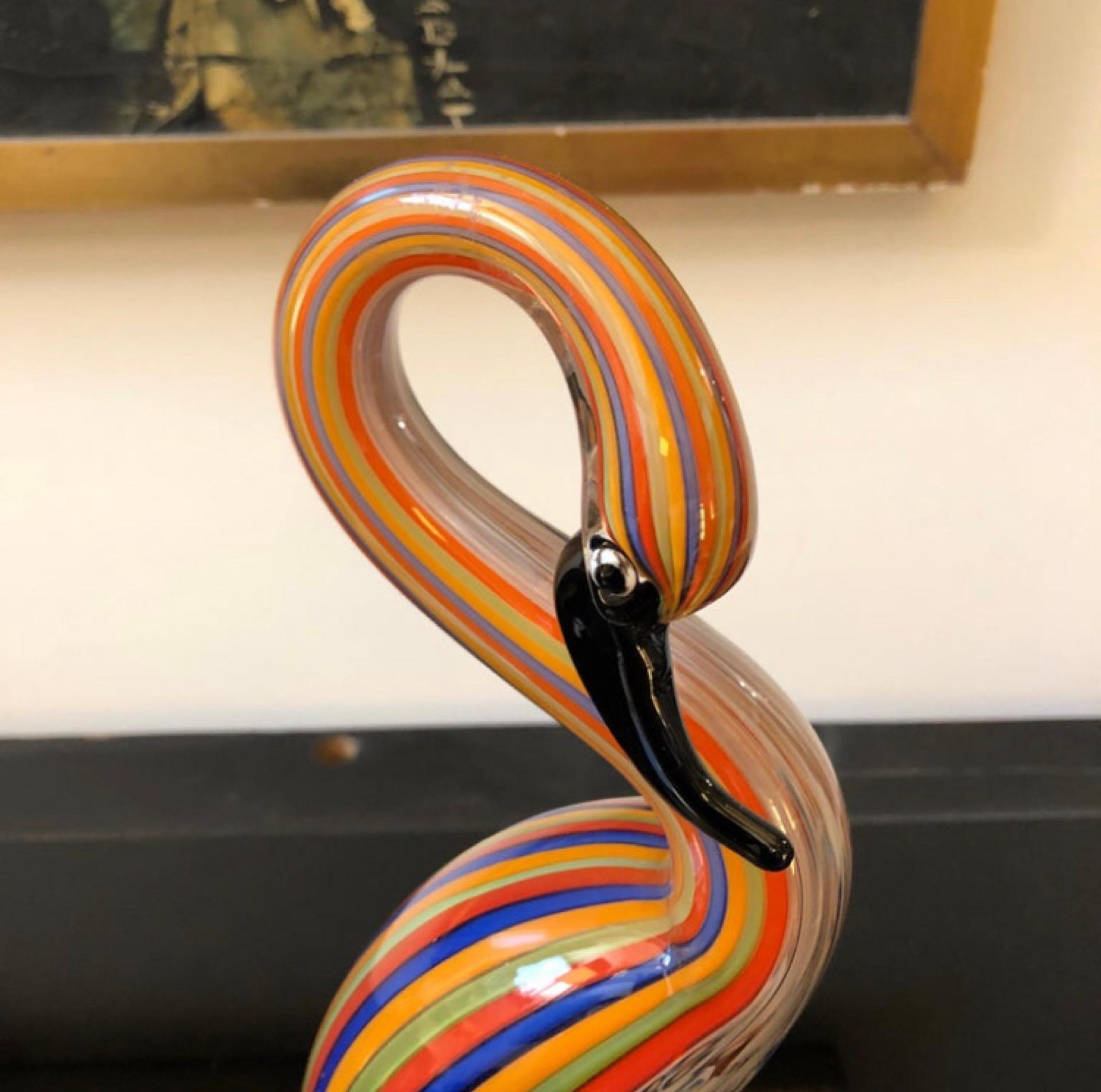 A polychrome striped Murano glass sculpture of a flamingo, designed and manufactured in Italy in the Seventies by Ferro & Lazzarini. It's in perfect conditions and labeled Lazzarini on a side. The Flamingo is a beautiful and unique piece of art
