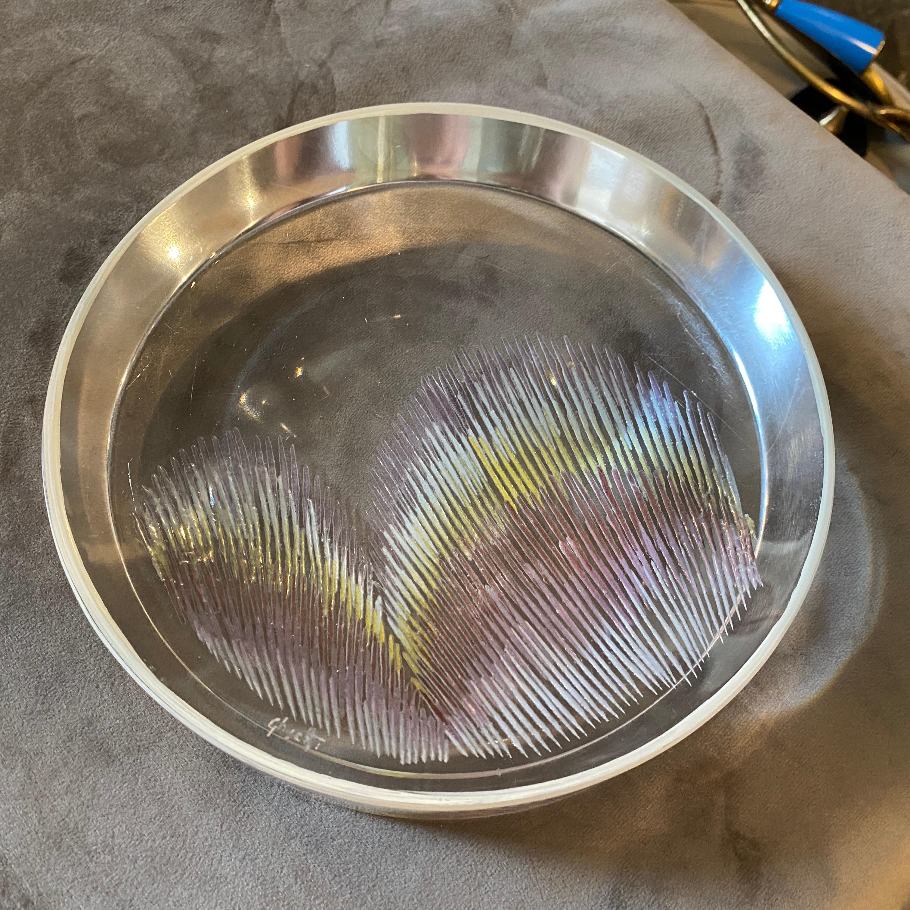 A rare ashtray made in Italy in the Eighties, it's signed on a side, transparent glass has been decorated with pink and yellow signs. It's in perfect conditions.