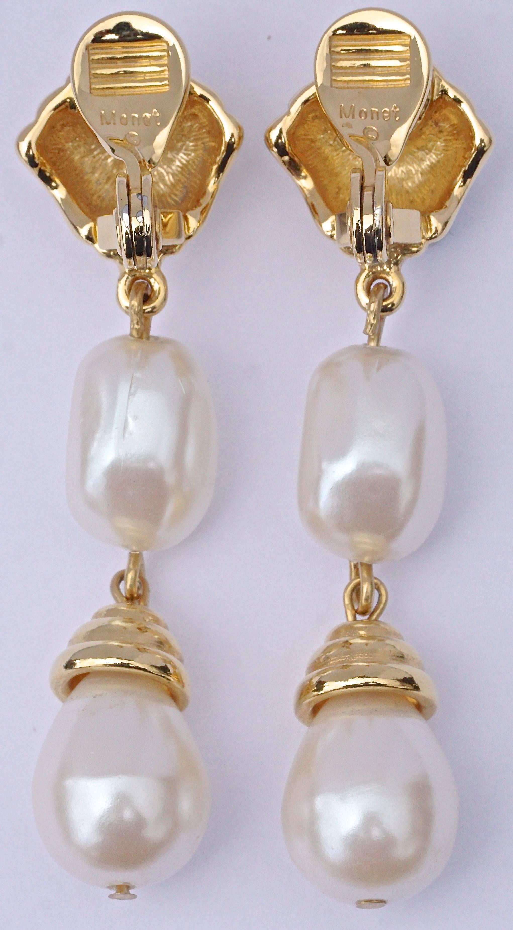 Stylish Monet gold tone clip on earrings featuring faux pearl drops. Length 5.7cm, 2.24 inches. These are high quality vintage 1980s Monet earrings, in very good condition.

Monet was founded in 1929 by Michael and Jay Chernow in Providence, Rhode