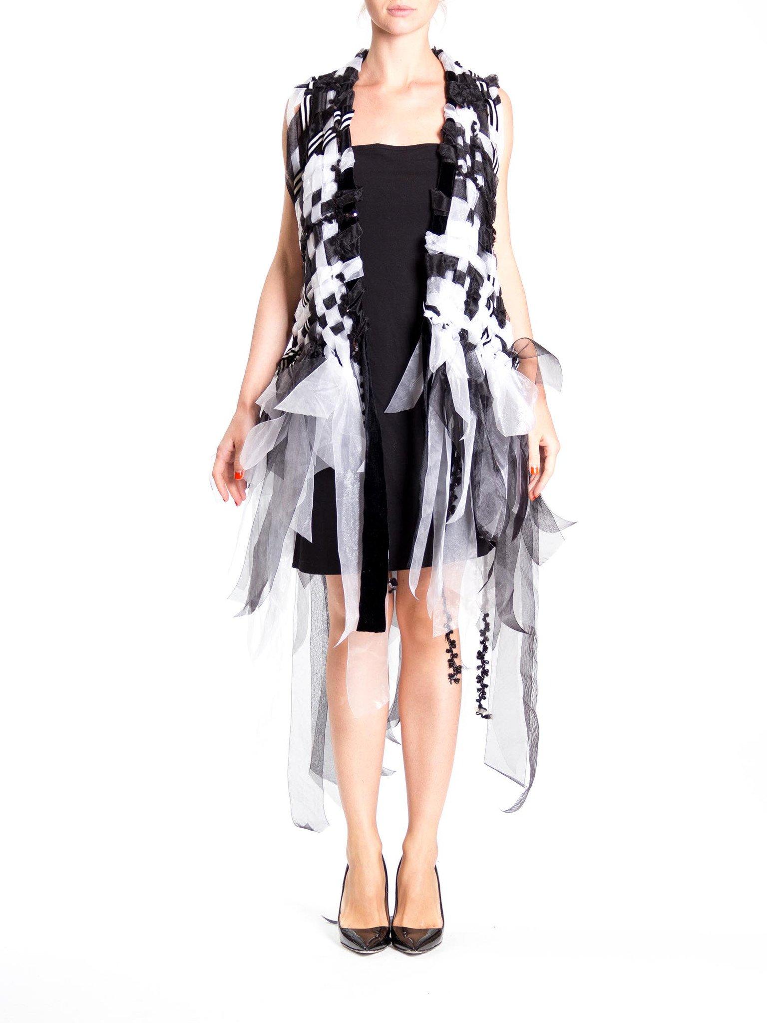 MORPHEW COLLECTION Black & White Hand Woven Ribbon  Vest With Fringe
MORPHEW COLLECTION is made entirely by hand in our NYC Ateliér of rare antique materials sourced from around the globe. Our sustainable vintage materials represent over a century