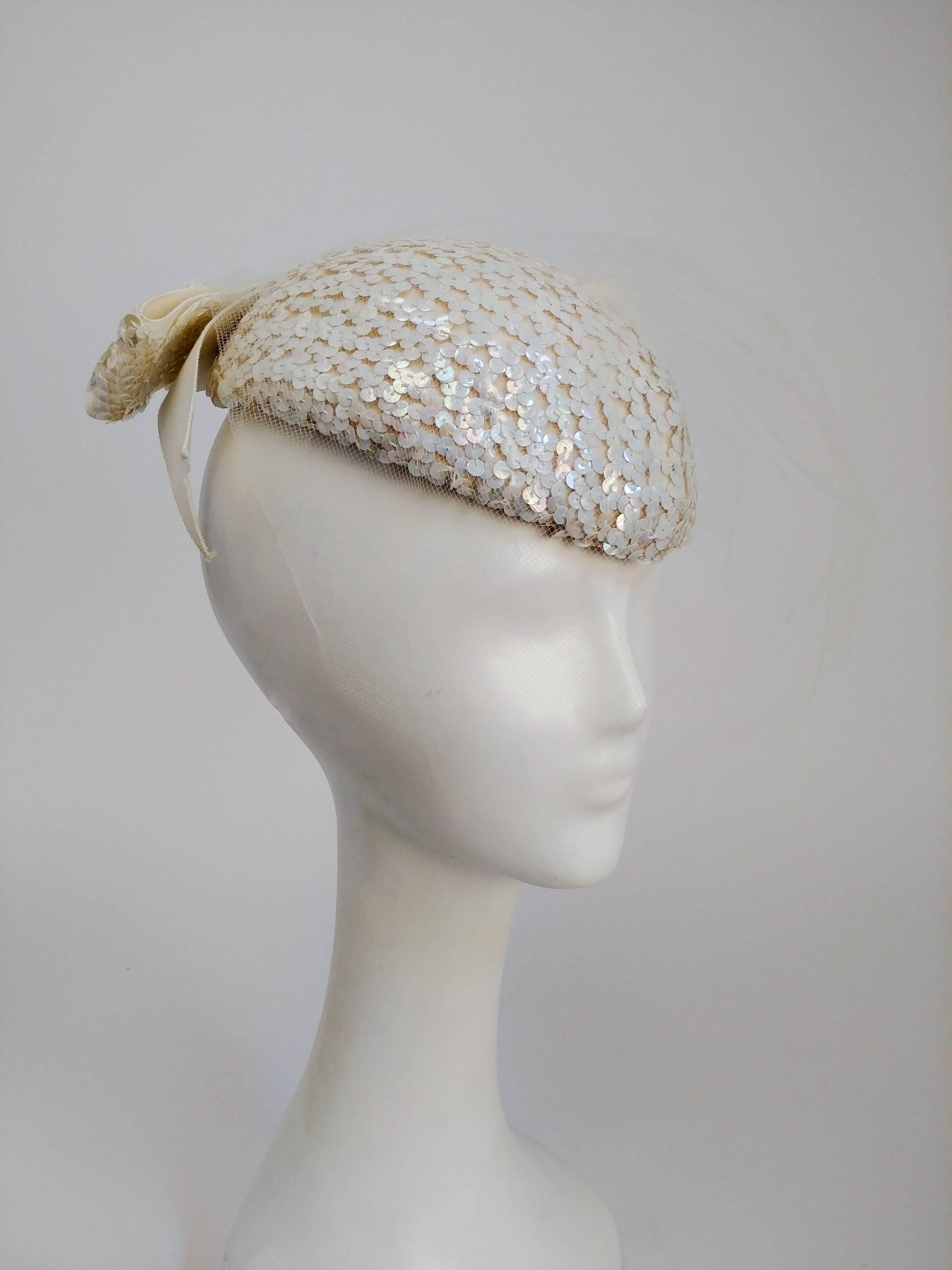 1980's Cream Sequin Hat with Vail. Cream sequin hat with veil and sequence ribbon on the back. 